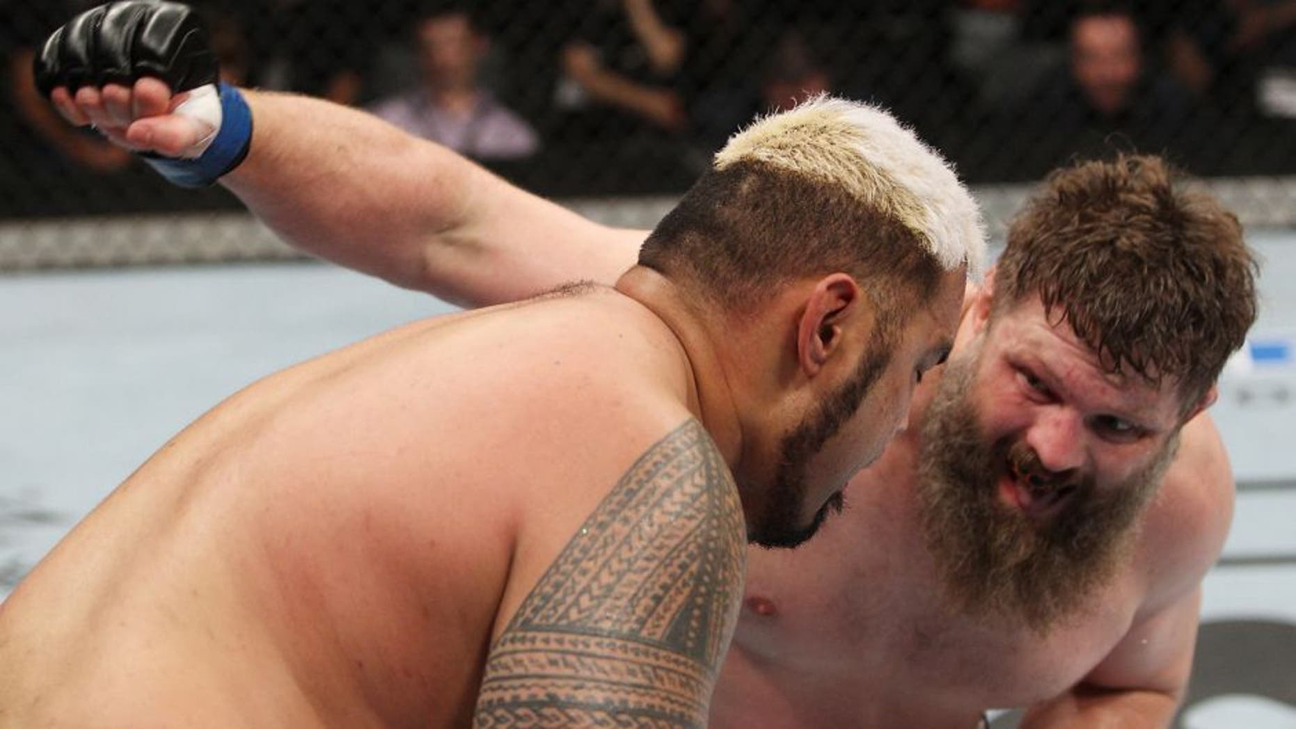 SAITAMA, JAPAN - SEPTEMBER 20: Roy Nelson throws a punch at Mark Hunt in their heavyweight bout during the UFC Fight Night event inside the Saitama Arena on September 20, 2014 in Saitama, Japan. (Photo by Mitch Viquez/Zuffa LLC/Zuffa LLC via Getty Images)