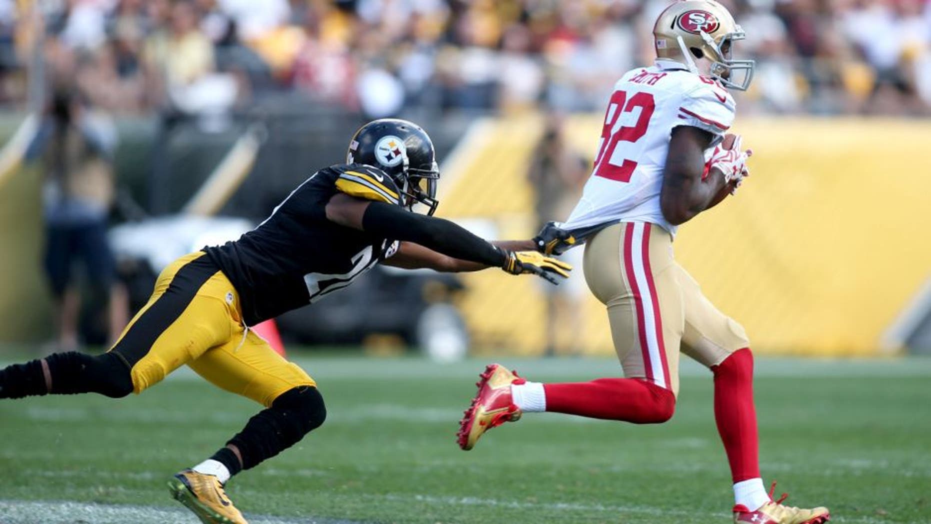 Sep 20, 2015; Pittsburgh, PA, USA; San Francisco 49ers wide receiver Torrey Smith (82) carries the ball away from Pittsburgh Steelers strong safety Will Allen (20) on a seventy-five yard touchdown catch during the fourth quarter at Heinz Field. The Steelers won 43-18. Mandatory Credit: Charles LeClaire-USA TODAY Sports