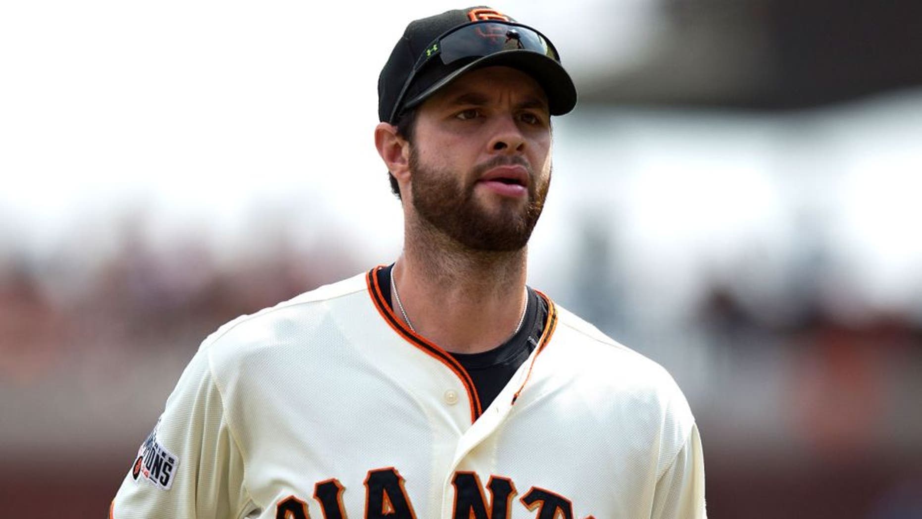 SAN FRANCISCO, CA - SEPTEMBER 13: Brandon Belt #9 of the San Francisco Giants returns to the dugout during the fourth inning against the San Diego Padres at AT&T Park on September 13, 2015 in San Francisco, California. The San Francisco Giants defeated the San Diego Padres 10-3. (Photo by Jason O. Watson/Getty Images)