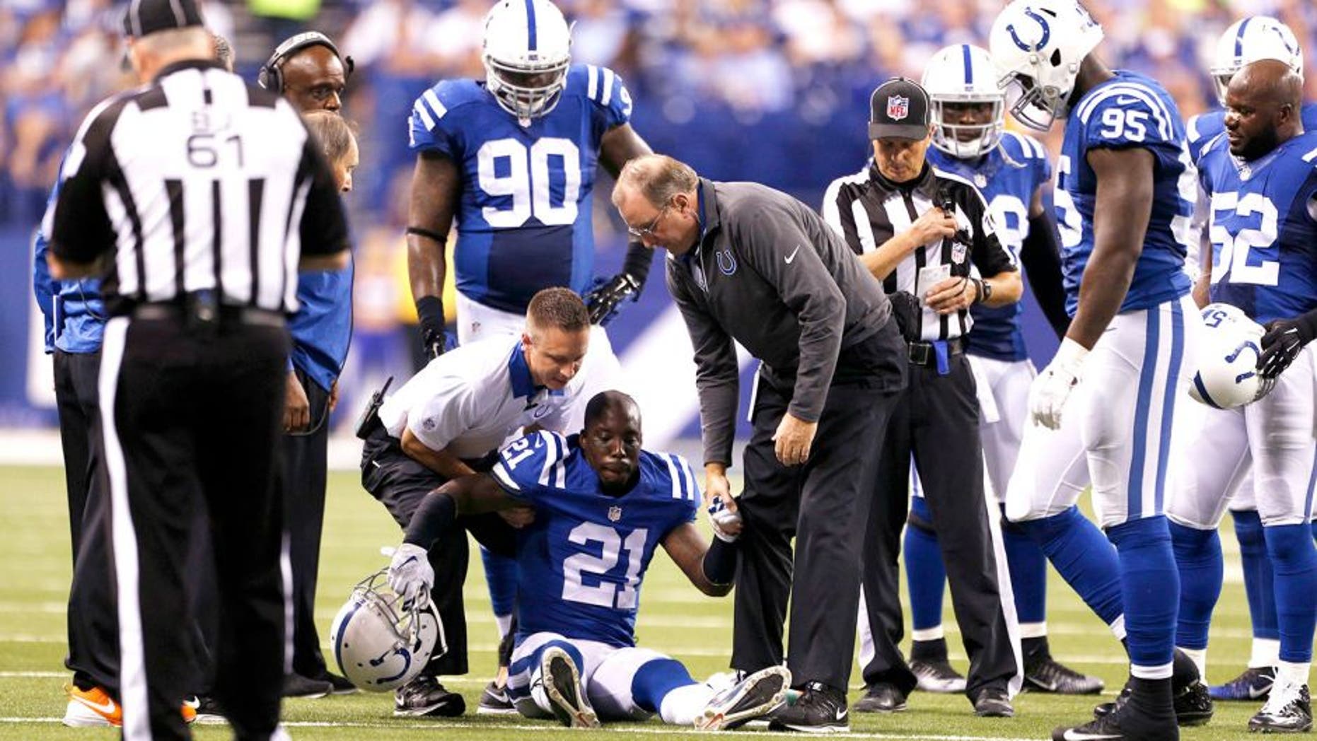 Sep 21, 2015; Indianapolis, IN, USA; Indianapolis Colts cornerback Vontae Davis (21) is helped off the ground after being hurt in a game against the New York Jets at Lucas Oil Stadium. Mandatory Credit: Brian Spurlock-USA TODAY Sports