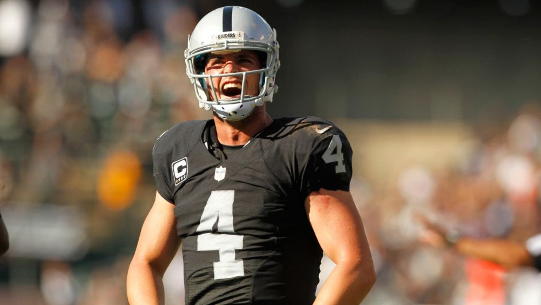 Sep 20, 2015; Oakland, CA, USA; Oakland Raiders quarterback Derek Carr (4) reacts after throwing a touchdown pass against the Baltimore Ravens in the fourth quarter at O.co Coliseum. The Raiders defeated the Ravens 37-33. Mandatory Credit: Cary Edmondson-USA TODAY Sports