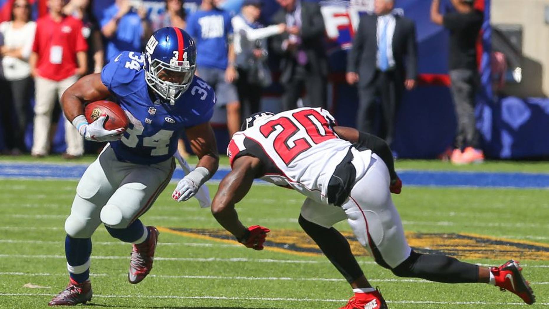 Sep 20, 2015; East Rutherford, NJ, USA; New York Giants running back Shane Vereen (34) runs with the ball while trying to avoid a tackle attempt by Atlanta Falcons defensive back Phillip Adams (20) during the first half at MetLife Stadium. Mandatory Credit: Ed Mulholland-USA TODAY Sports
