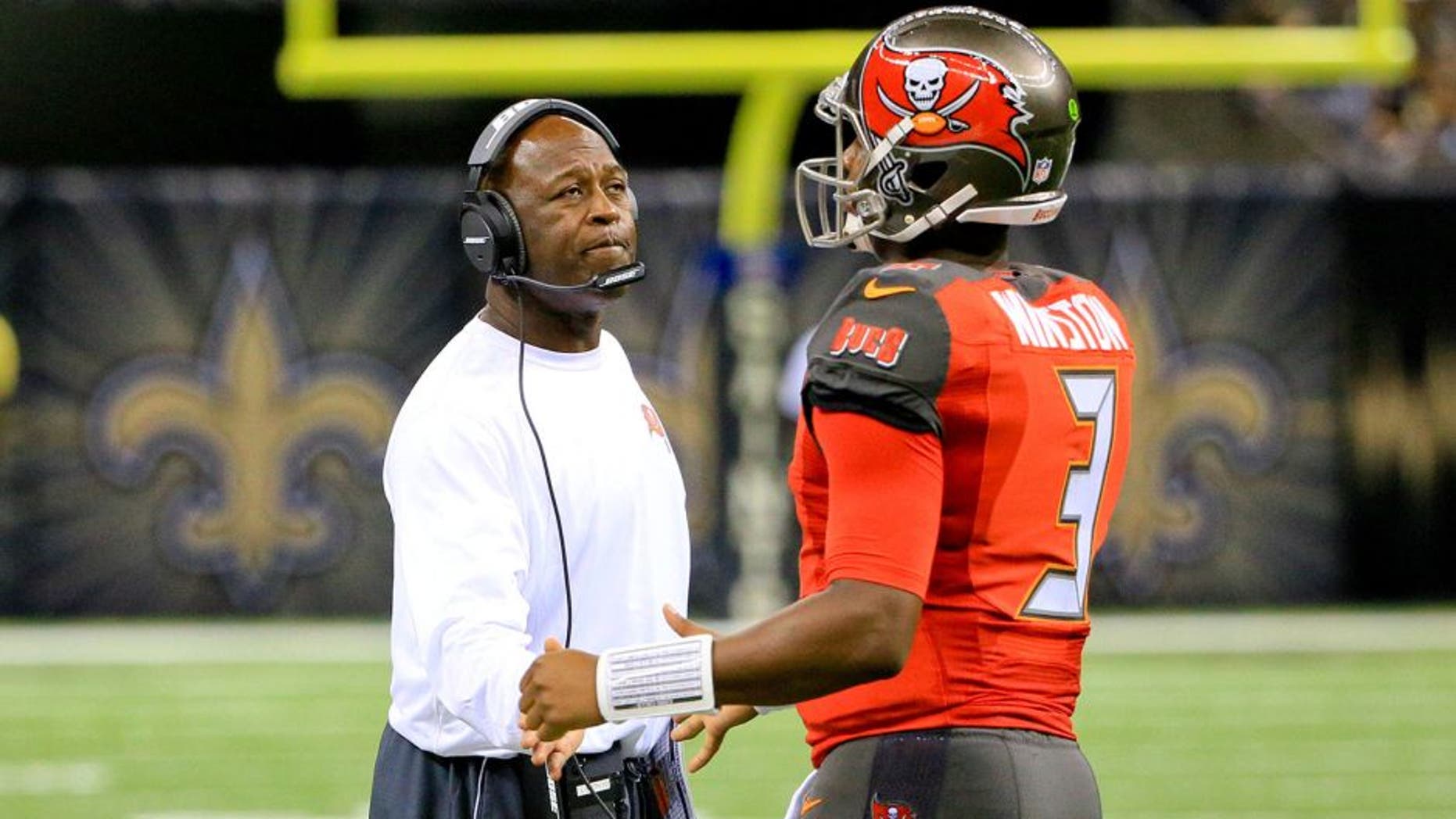 Sep 20, 2015; New Orleans, LA, USA; Tampa Bay Buccaneers head coach Lovie Smith (L) talks to quarterback Jameis Winston (3) during the second half against the New Orleans Saints at the Mercedes-Benz Superdome. The Buccaneers won 26-19. Mandatory Credit: Derick E. Hingle-USA TODAY Sports