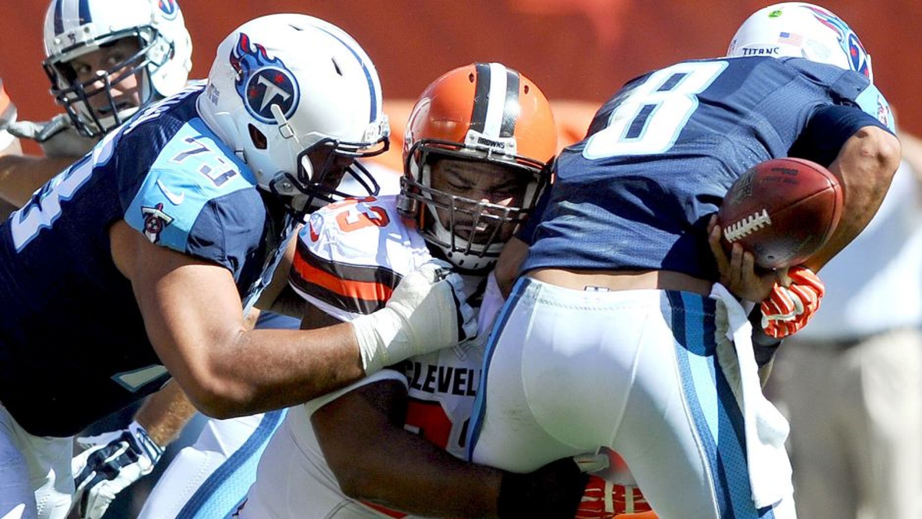 Sep 20, 2015; Cleveland, OH, USA; Cleveland Browns defensive end John Hughes (93) sacks Tennessee Titans quarterback Marcus Mariota (8) during the second half at FirstEnergy Stadium. The Browns won 28-14. Mandatory Credit: Ken Blaze-USA TODAY Sports