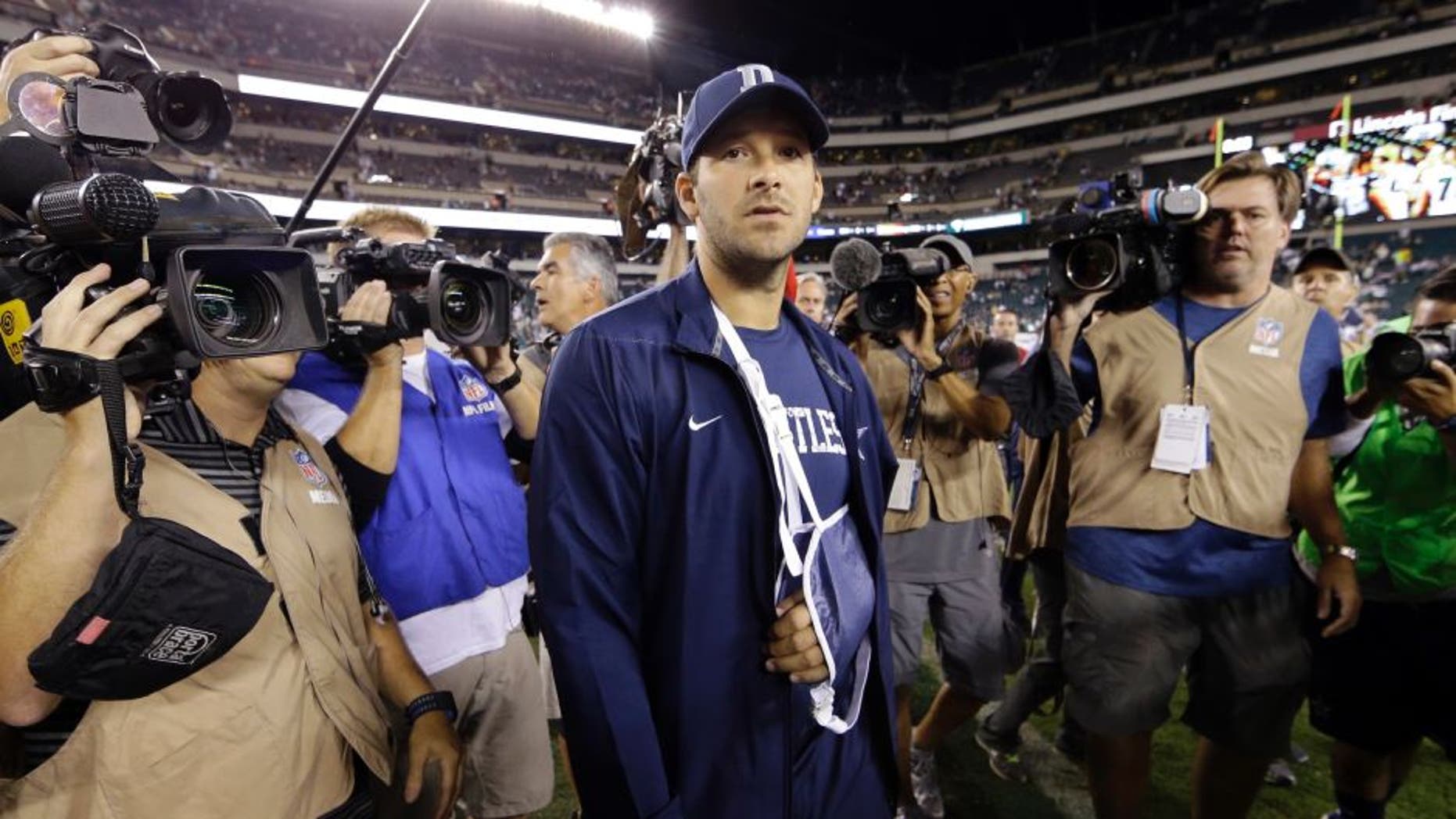 Injured Dallas Cowboys quarterback Tony Romo walks the field after an NFL football game against the Philadelphia Eagles, Sunday, Sept. 20, 2015, in Philadelphia. Dallas won 20-10. (AP Photo/Matt Rourke)