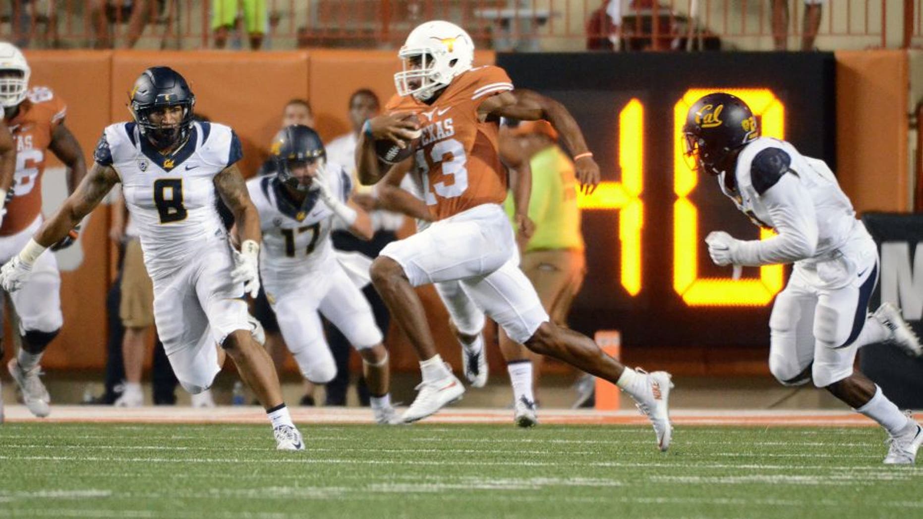 Sep 19, 2015; Austin, TX, USA; Texas Longhorns quarterback Jerrod Heard (13) carries the ball against the California Golden Bears during the second quarter at Darrell K Royal-Texas Memorial Stadium. Mandatory Credit: Brendan Maloney-USA TODAY Sports
