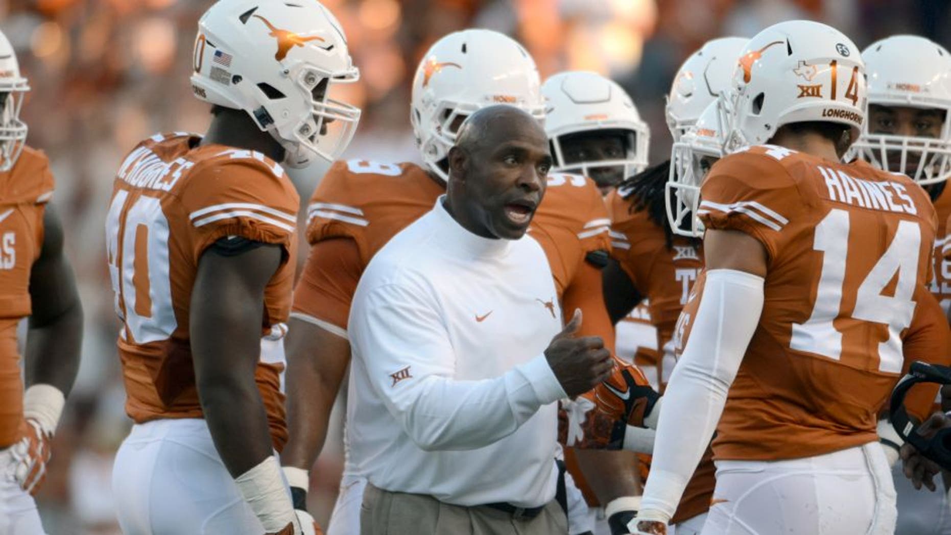 Sep 12, 2015; Austin, TX, USA; Texas Longhorns head coach Charlie Strong (center) talks to his team against the Rice Owls during the first quarter at Darrell K Royal-Texas Memorial Stadium. Mandatory Credit: Brendan Maloney-USA TODAY Sports