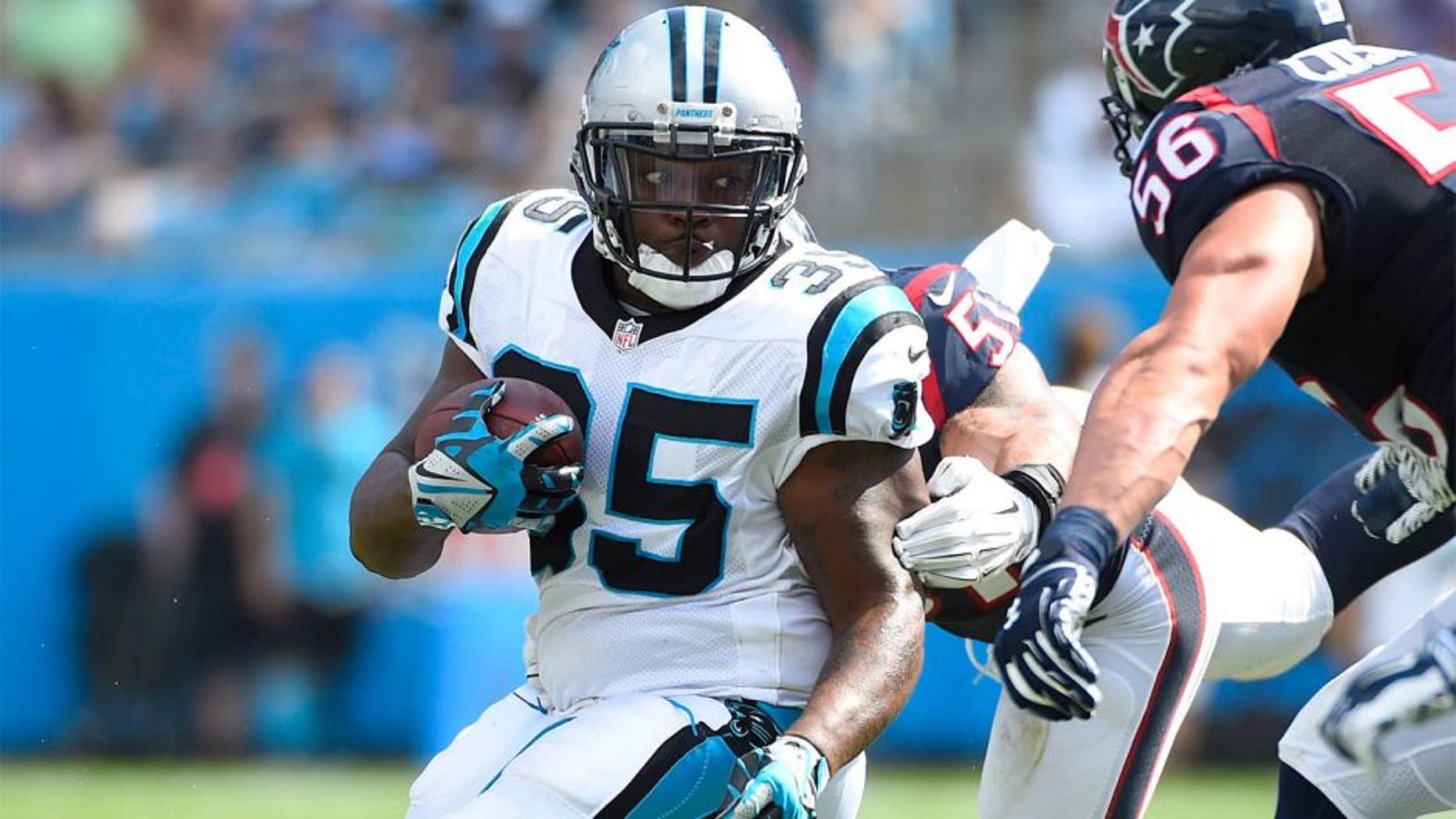 Sep 20, 2015; Charlotte, NC, USA; Carolina Panthers fullback Mike Tolbert (35) with the ball as Houston Texans outside linebacker John Simon (51) and inside linebacker Brian Cushing (56) defend in the third quarter. The Panthers defeated the Texans 24-17 at Bank of America Stadium. Mandatory Credit: Bob Donnan-USA TODAY Sports