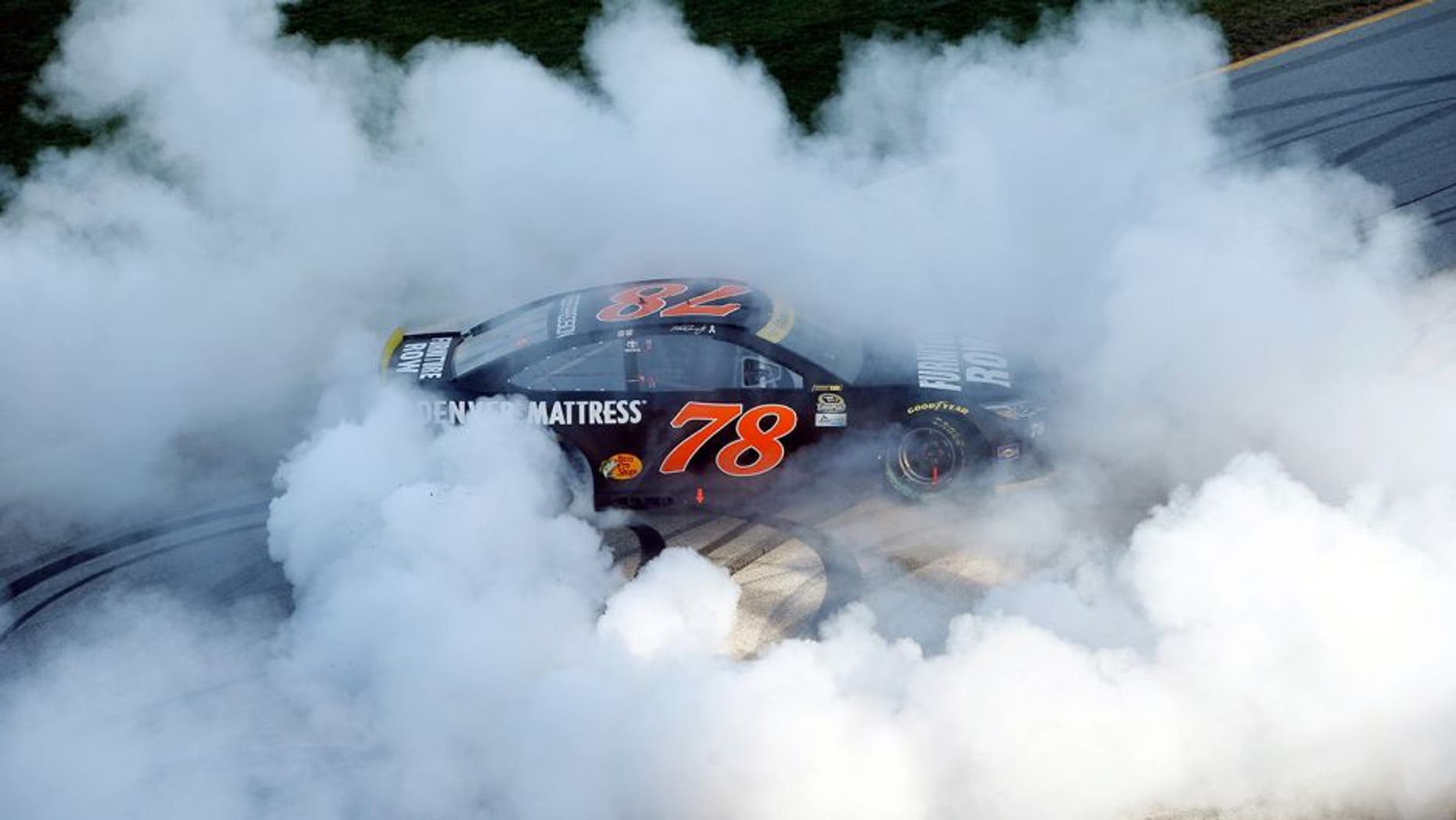 JOLIET, IL - SEPTEMBER 18: Martin Truex Jr, driver of the #78 Furniture Row/Denver Mattress Toyota, celebrates with a burnout after winning the NASCAR Sprint Cup Series Teenage Mutant Ninja Turtles 400 at Chicagoland Speedway on September 18, 2016 in Joliet, Illinois. (Photo by Brian Lawdermilk/NASCAR via Getty Images)
