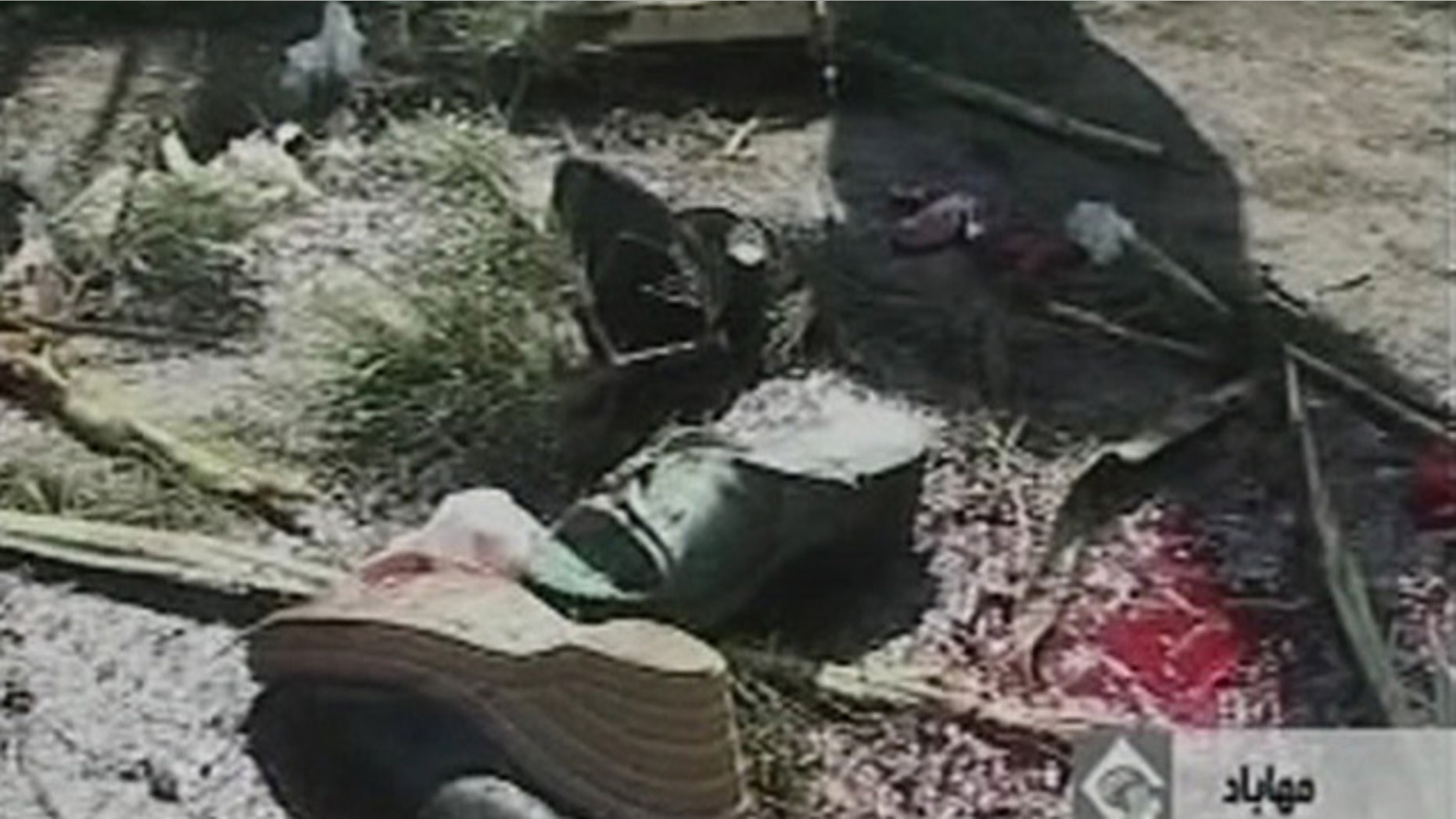 Sept. 22: Bloodstained debris litter the street after a bomb blast in Mahabad Iran.