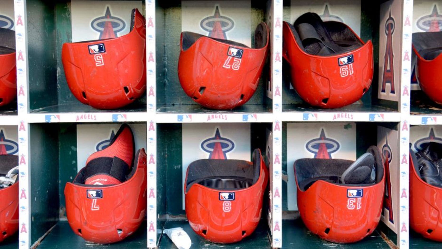 Sep 19, 2014; Anaheim, CA, USA; General view of Los Angeles Angels helmets of Albert Pujols (5), Mike Trout (27), Efren Navarro (19), Collin Cowgill (7), John McDonald (8) and Luis Jimenez (13) in the dugout before the game against the Texas Rangers at Angel Stadium of Anaheim. Mandatory Credit: Kirby Lee-USA TODAY Sports