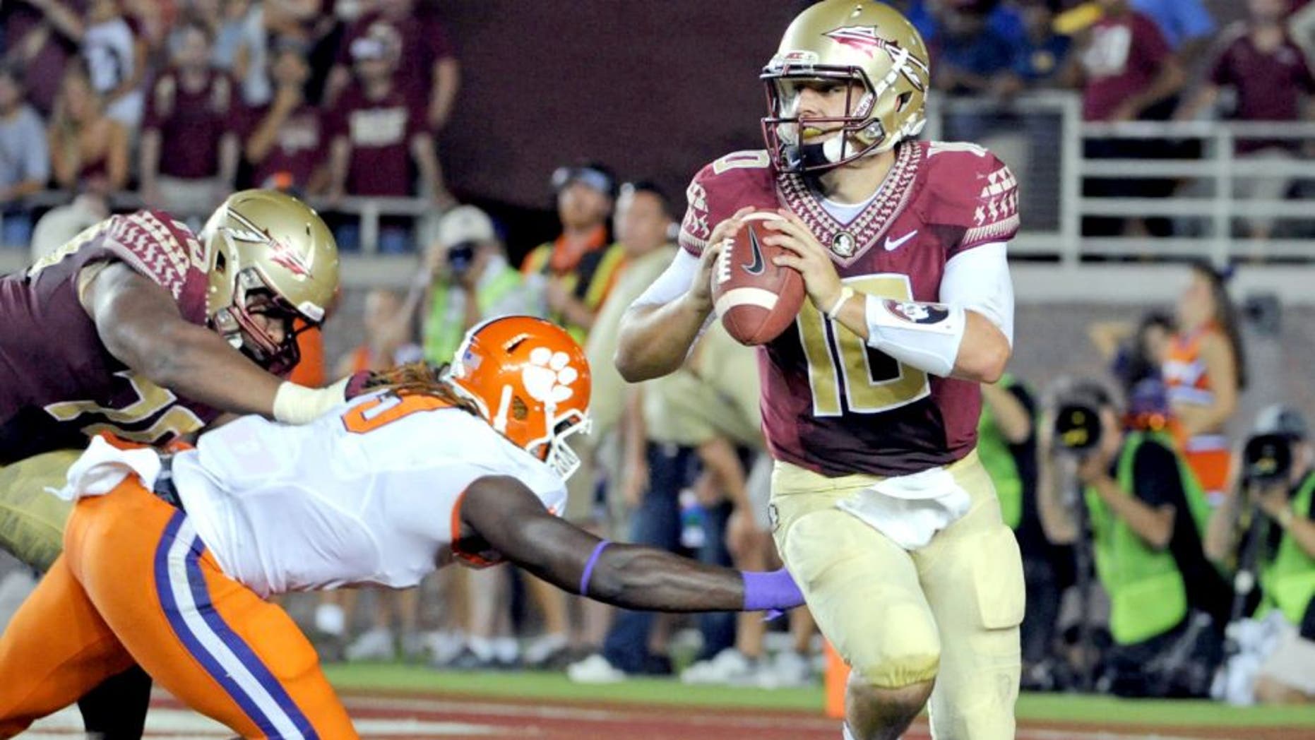 Sep 20, 2014; Tallahassee, FL, USA; Florida State Seminoles quarterback Sean Maguire (10) is pressured during the first half against the Clemson Tigers at Doak Campbell Stadium. Mandatory Credit: Melina Vastola-USA TODAY Sports