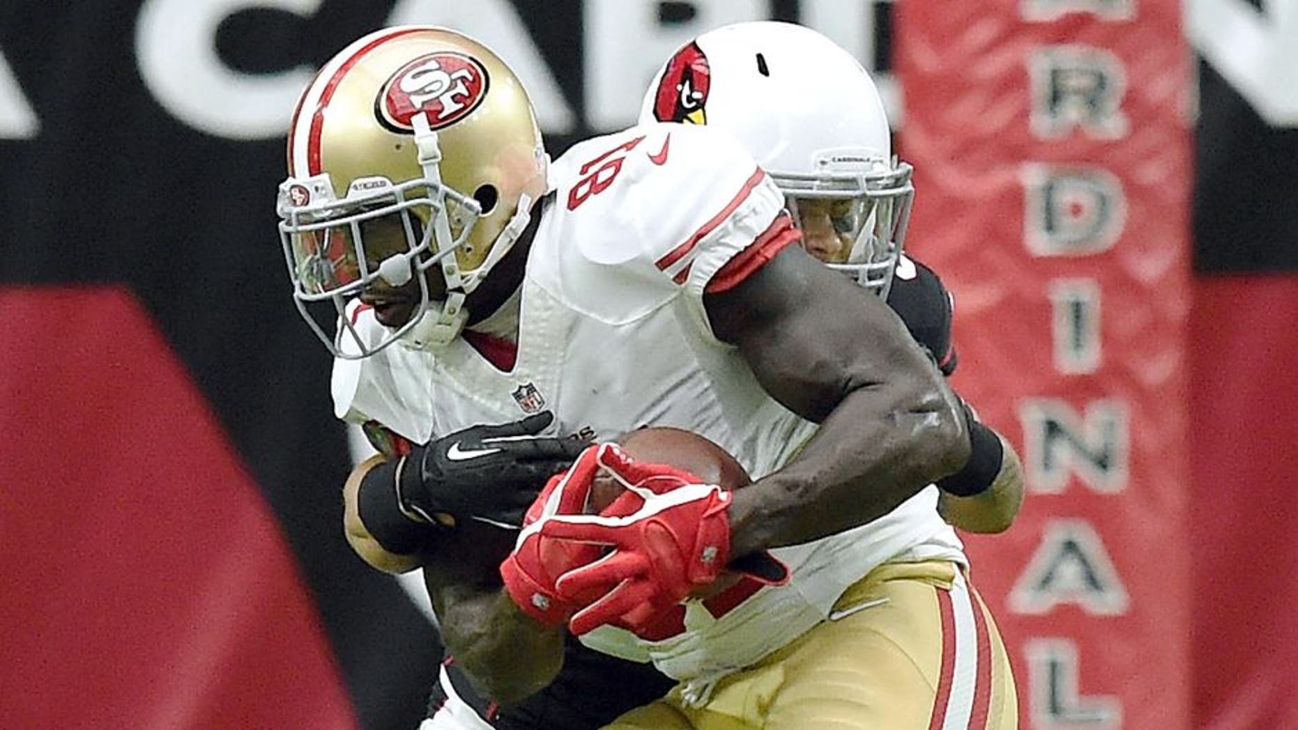 GLENDALE, AZ - SEPTEMBER 21: Wide receiver Anquan Boldin #81 of the San Francisco 49ers is hit by safety Tyrann Mathieu #32 of the Arizona Cardinals during the second quarter of the NFL game at University of Phoenix Stadium on September 21, 2014 in Glendale, Arizona. (Photo by Norm Hall/Getty Images)