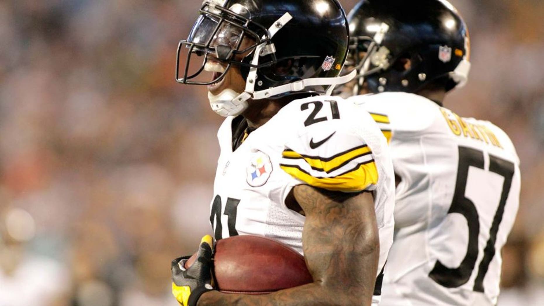 Pittsburgh Steelers' Robert Golden (21) reacts after recovering a muffed punt in the end zone for a touchdown against the Carolina Panthers during the second half of an NFL football game in Charlotte, N.C., Sunday, Sept. 21, 2014. (AP Photo/Bob Leverone)
