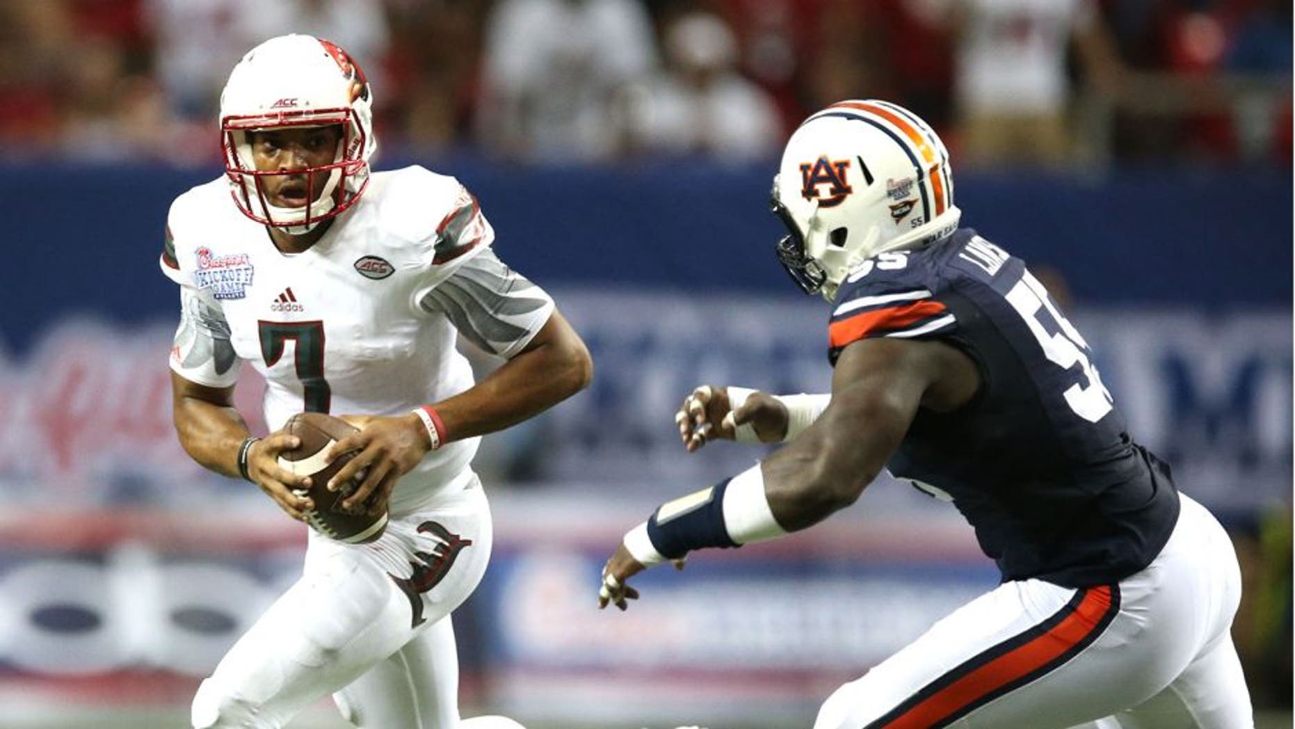 Sep 5, 2015; Atlanta, GA, USA; Louisville Cardinals quarterback Reggie Bonnafon (7) is chased by Auburn Tigers defensive lineman Carl Lawson (55) and Kris Frost (17) during the second quarter in the 2015 Chick-fil-A Kickoff Game at the Georgia Dome. Mandatory Credit: Jason Getz-USA TODAY Sports