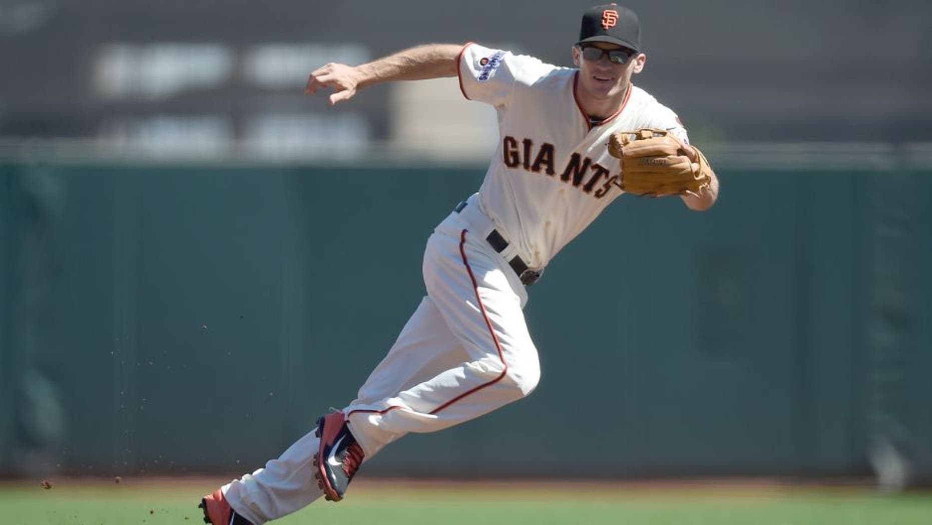 SAN FRANCISCO, CA - SEPTEMBER 19: Kelby Tomlinson #37 of the San Francisco Giants watches a ground ball go past him for an rbi basehit off the bat of David Peralta #6 of the Arizona Diamondbacks in the top of th first inning at AT&T Park on September 19, 2015 in San Francisco, California. (Photo by Thearon W. Henderson/Getty Images)