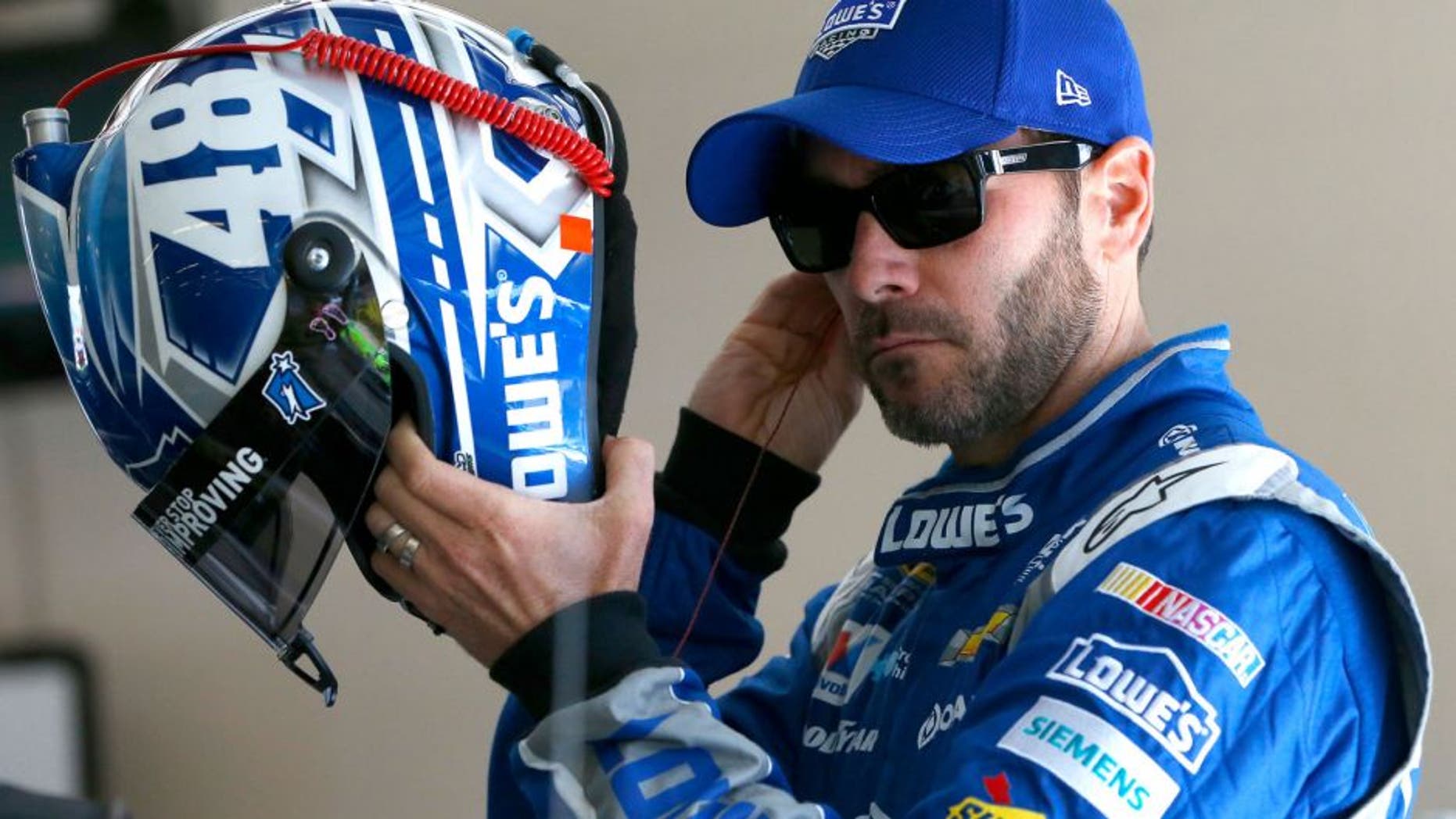 JOLIET, IL - SEPTEMBER 19: Jimmie Johnson, driver of the #48 Lowe's Chevrolet, stands in the garage area during practice for the NASCAR Sprint Cup Series MyAFibRisk.com 400 at Chicagoland Speedway on September 19, 2015 in Joliet, Illinois. (Photo by Jonathan Ferrey/Getty Images)