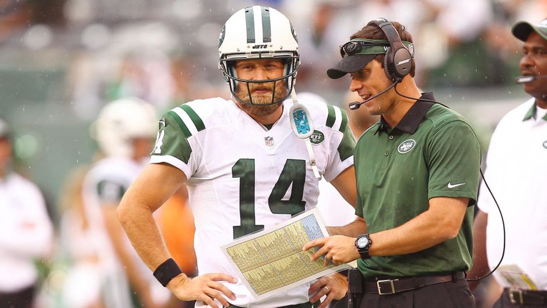 Sep 13, 2015; East Rutherford, NJ, USA; New York Jets quarterback Ryan Fitzpatrick (14) talks with a coach during the second half at MetLife Stadium. Mandatory Credit: Danny Wild-USA TODAY Sports