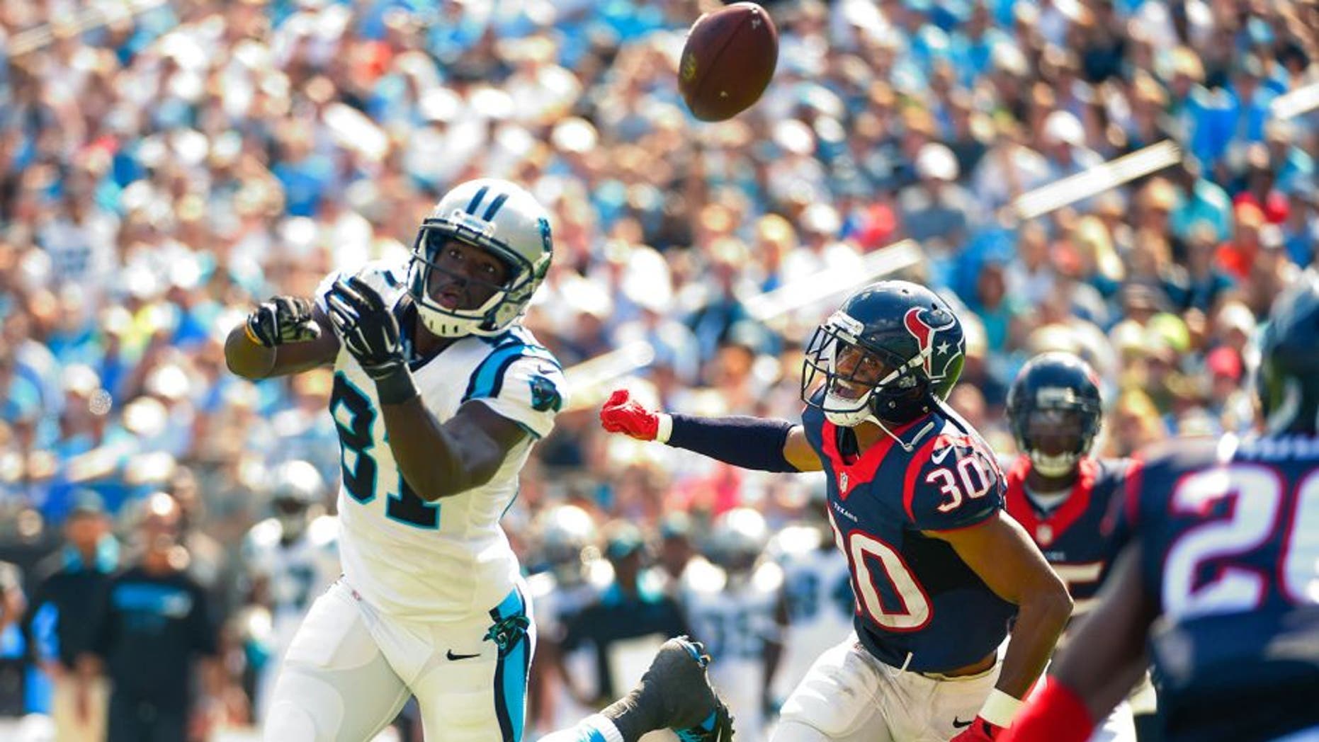 Sep 20, 2015; Charlotte, NC, USA; Carolina Panthers wide receiver Kevin Norwood (81) attempts to catch the ball as Houston Texans cornerback Kevin Johnson (30) defends in the second quarter at Bank of America Stadium. Mandatory Credit: Bob Donnan-USA TODAY Sports
