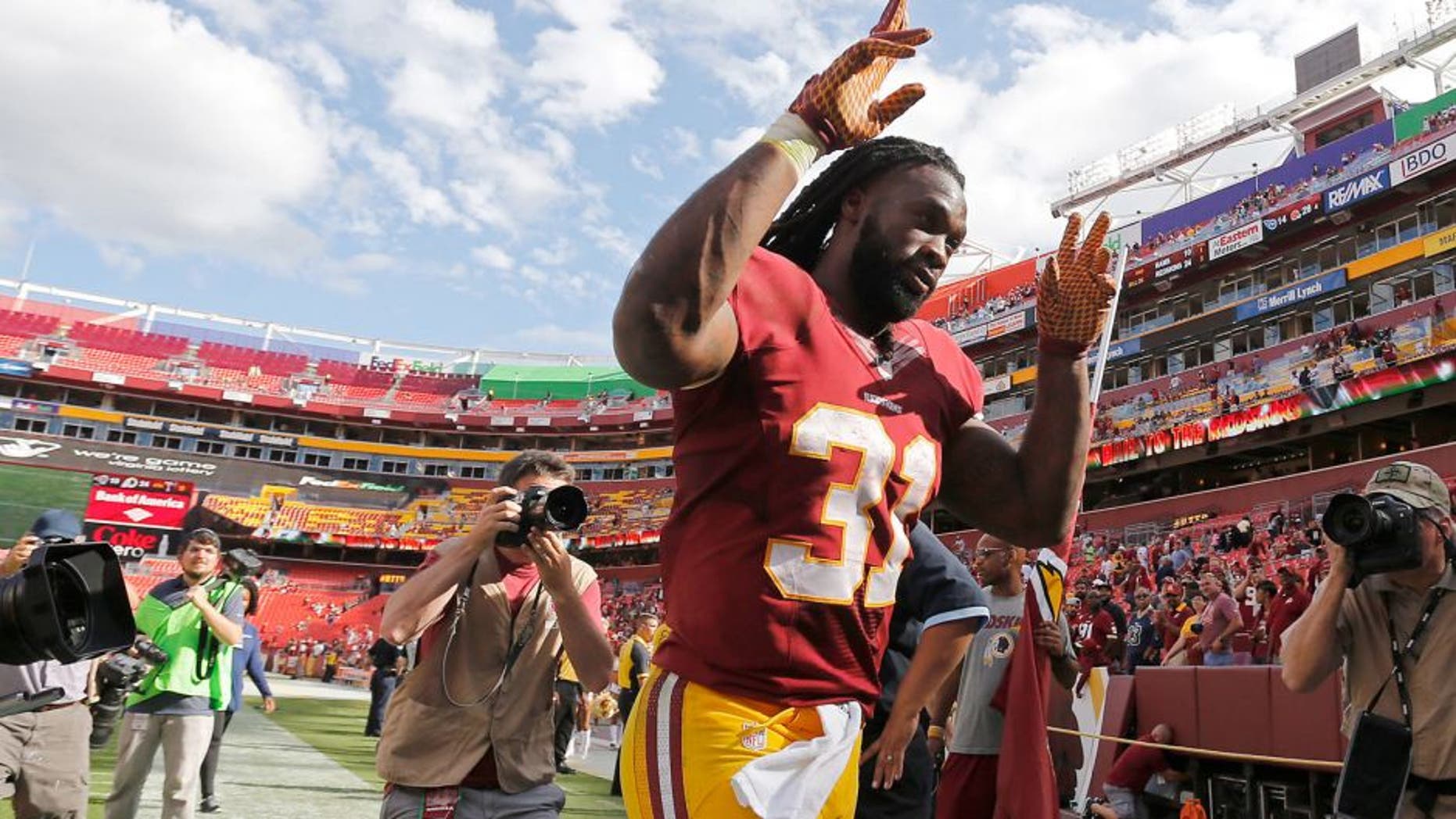 Sep 20, 2015; Landover, MD, USA; Washington Redskins running back Matt Jones (31) celebrates while leaving the field after the Redskins' game against the St. Louis Rams at FedEx Field. The Redskins won 24-10. Mandatory Credit: Geoff Burke-USA TODAY Sports
