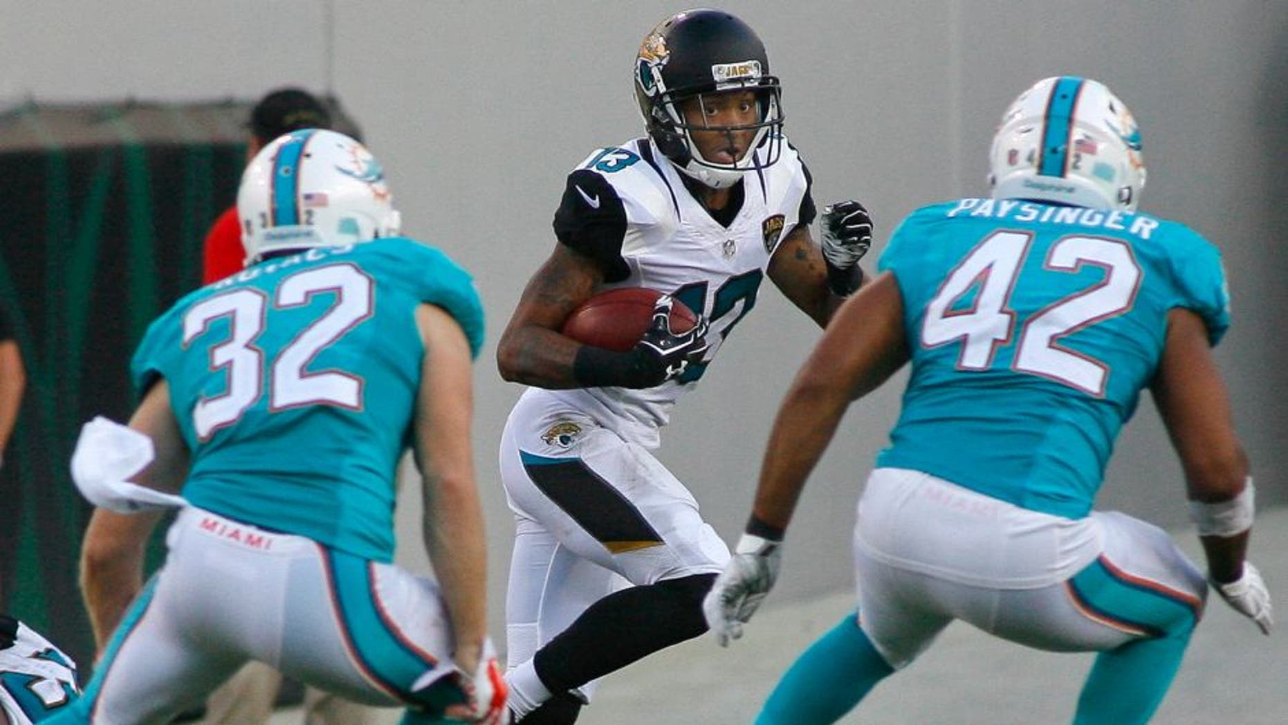 Sep 20, 2015; Jacksonville, FL, USA; Jacksonville Jaguars wide receiver Rashad Greene (13) cuts across the field for a big punt return late in the fourth quarter against the Miami Dolphins at EverBank Field. The Jacksonville Jaguars won 23-20. Mandatory Credit: Phil Sears-USA TODAY Sports