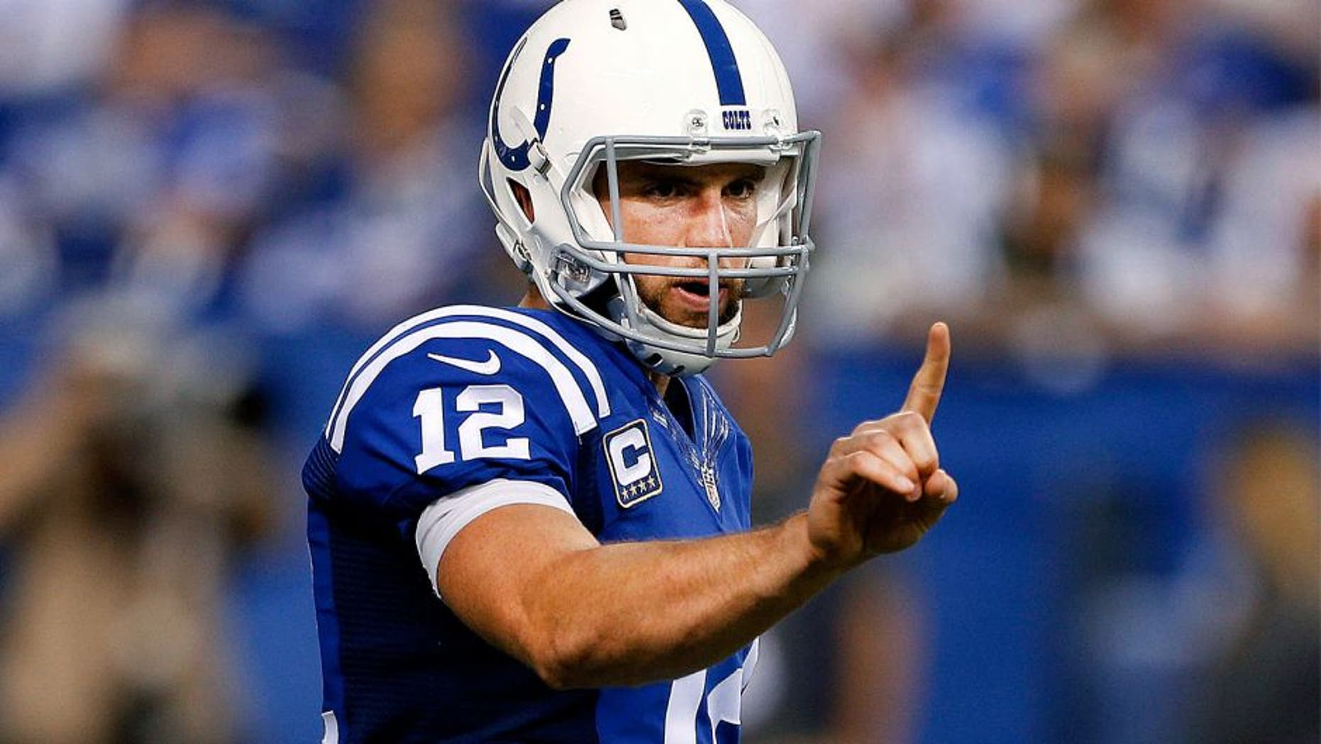 Sep 21, 2015; Indianapolis, IN, USA; Indianapolis Colts quarterback Andrew Luck (12) motions at the line of scrimmage against the New York Jets at Lucas Oil Stadium. New York Jets defeat the Indianapolis Colts 20-7. Mandatory Credit: Brian Spurlock-USA TODAY Sports
