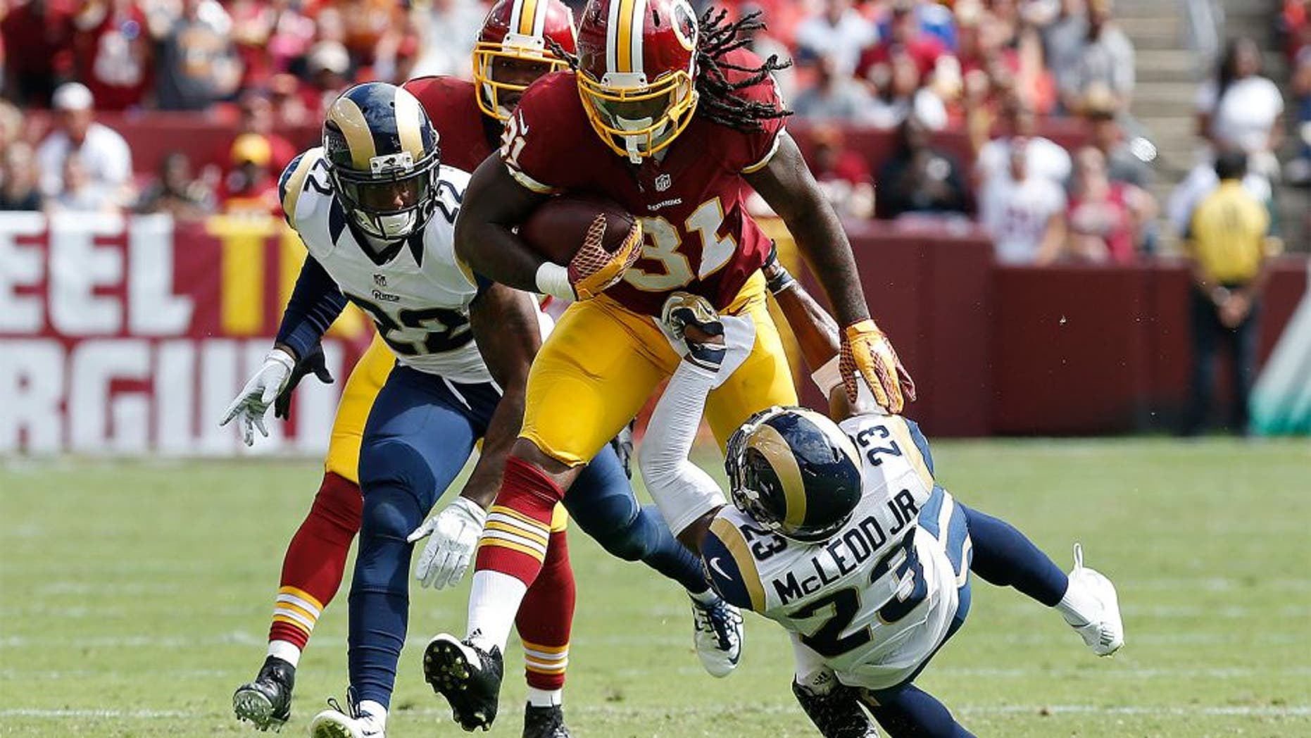 Sep 20, 2015; Landover, MD, USA; Washington Redskins running back Matt Jones (31) carries the ball as St. Louis Rams free safety Rodney McLeod (23) attempts to make the tackle in the second quarter at FedEx Field. The Redskins won 24-10. Mandatory Credit: Geoff Burke-USA TODAY Sports