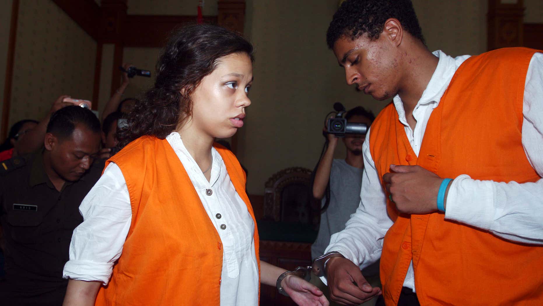 FILE - In this March 31, 2015 file photo, Heather Mack, 19, left, and her boyfriend Tommy Schaefer, 21, of Chicago, are handcuffed as they arrive at a courtroom during their trial in Bali, Indonesia.