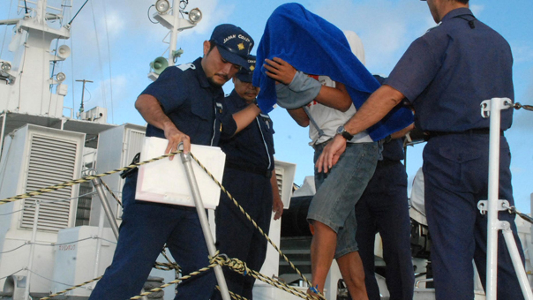 Sept. 8: Japan Coast Guard personnel disembark Zhan Qixiong, the 41-year-old Chinese captain of a Chinese fishing boat, center, at a port on Ishigaki island. The boat collided with two Japanese patrol vessels near disputed islands causing more than 2 weeks of strained relations between the two countries, before Japan announced the captain's release.