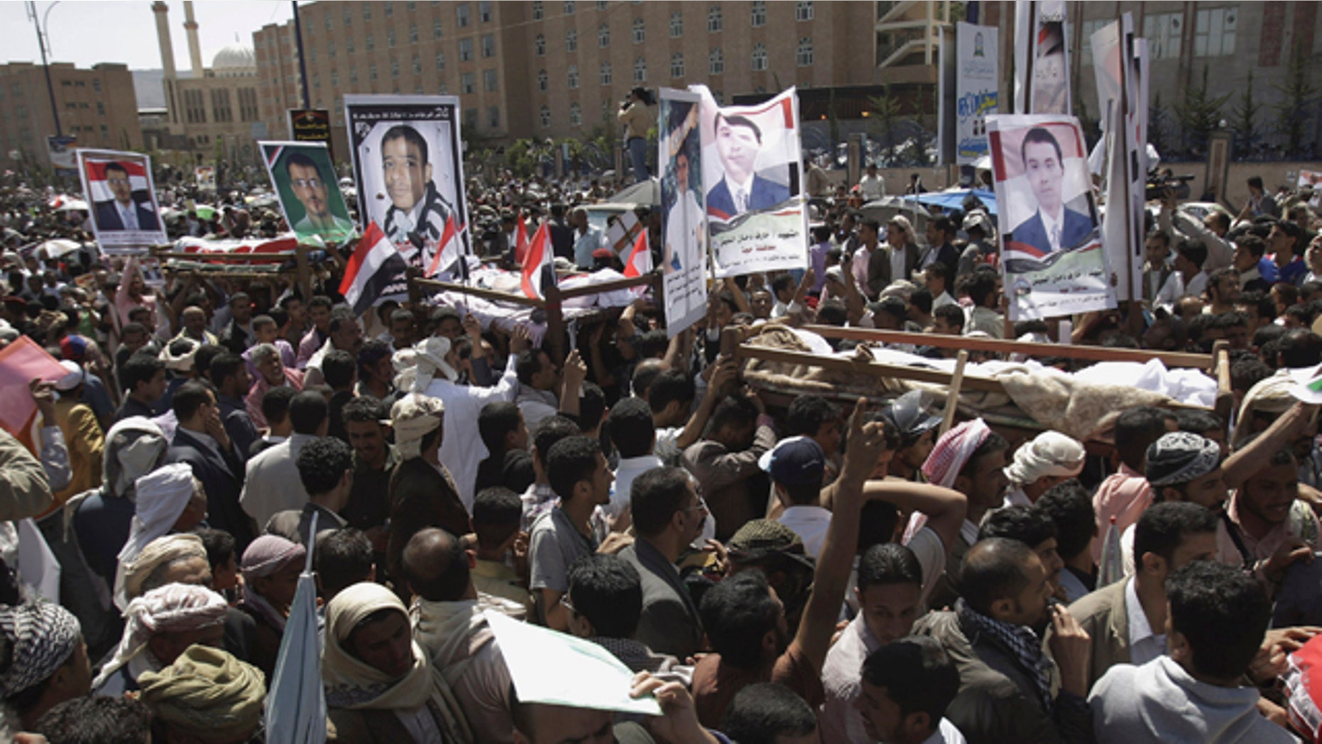 Sept. 21: Anti-government protestors carry the bodies of Yemeni men who were killed in the recent clashes with security forces, during their funeral procession in Sanaa, Yemen.