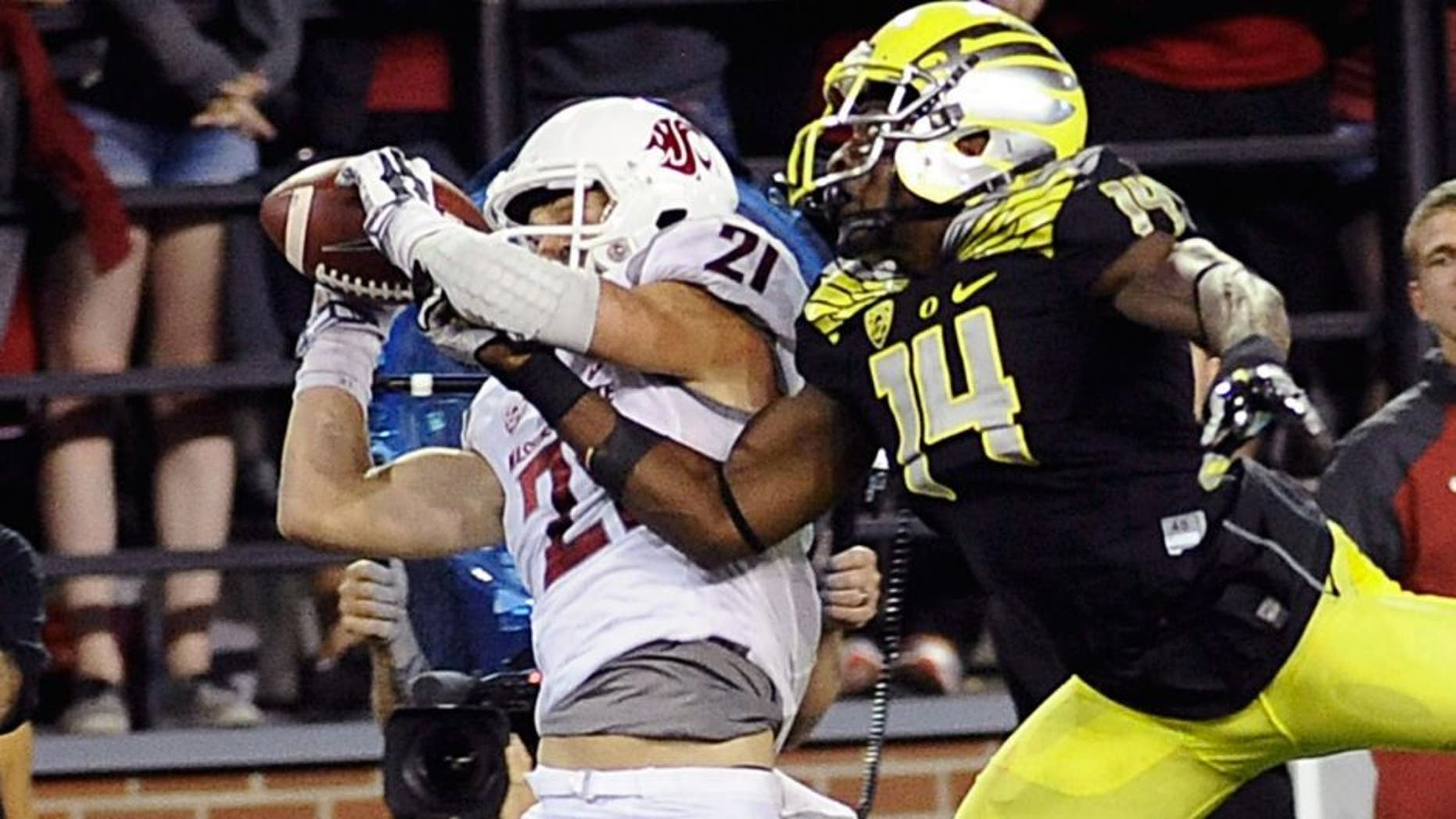 Sep 20, 2014; Pullman, WA, USA; Washington State Cougars wide receiver River Cracraft (21) makes a catch against Oregon Ducks defensive back Ifo Ekpre-Olomu (14) during the second half at Martin Stadium. The Ducks beat Cougars 38-31. Mandatory Credit: James Snook-USA TODAY Sports