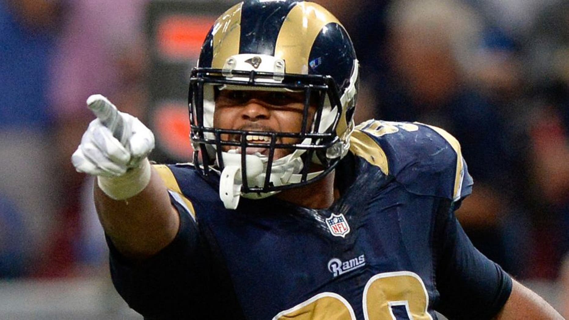 Sep 13, 2015; St. Louis, MO, USA; St. Louis Rams defensive tackle Aaron Donald (99) celebrates after sacking Seattle Seahawks quarterback Russell Wilson (not pictured) during the second half at the Edward Jones Dome. The Rams defeated the Seahawks 34-31 in overtime. Mandatory Credit: Jeff Curry-USA TODAY Sports