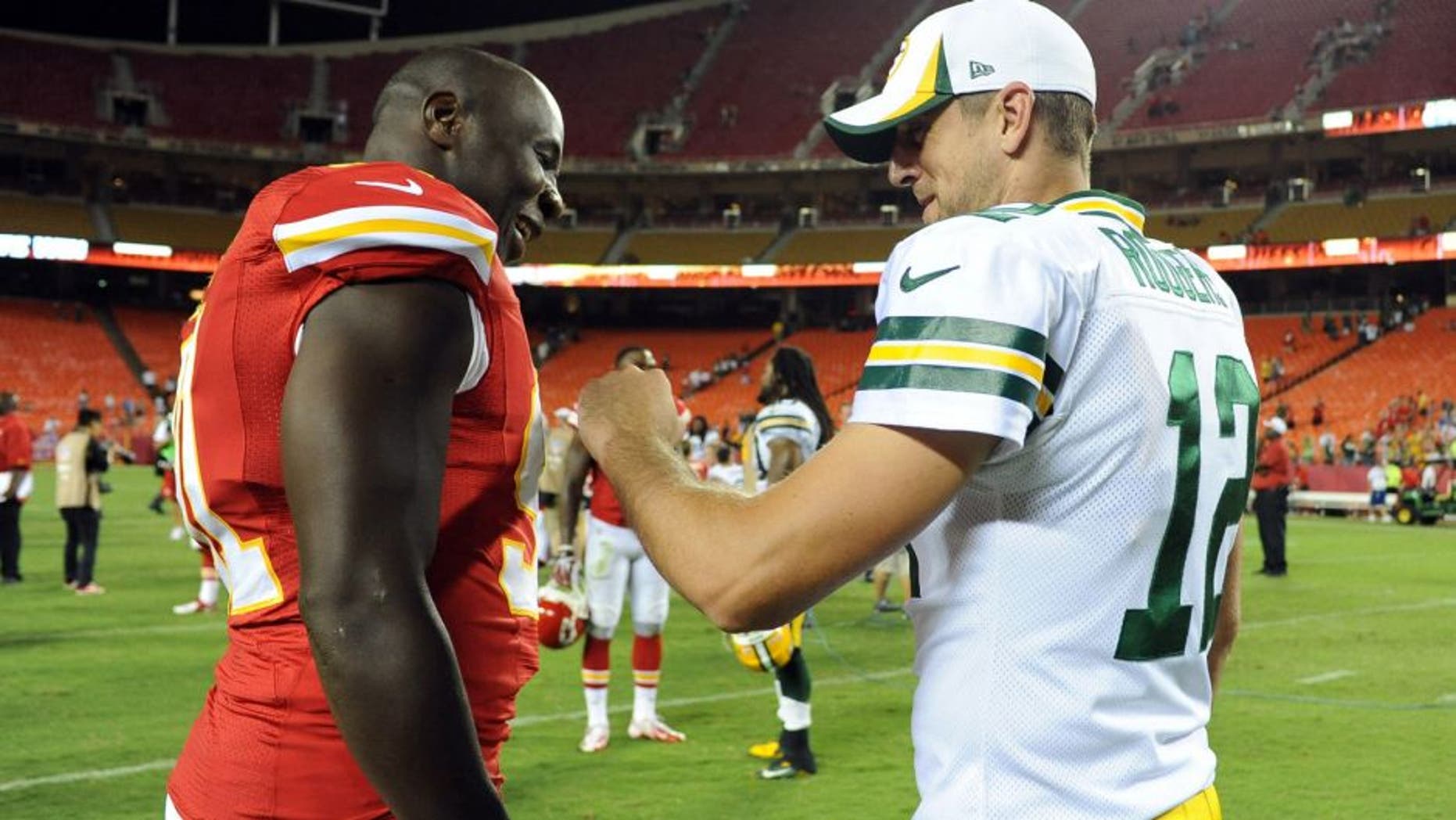 Aug 29, 2013; Kansas City, MO, USA; Kansas City Chiefs linebacker Tamba Hali (91) talks to Green Bay Packers quarterback Aaron Rodgers (12) after the game at Arrowhead Stadium. Kansas City won the game 30-8. Mandatory Credit: John Rieger-USA TODAY Sports