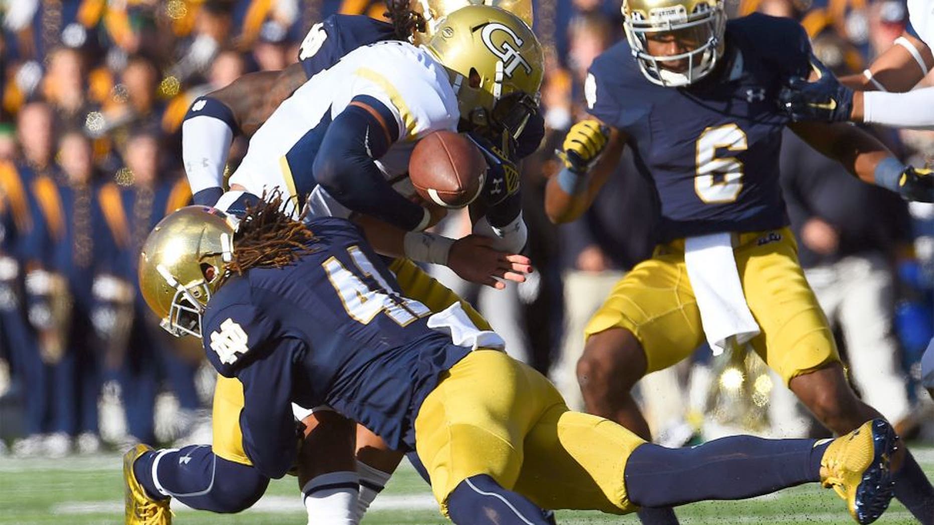 Sep 19, 2015; South Bend, IN, USA; Georgia Tech Yellow Jackets quarterback Justin Thomas (5) fumbles the ball against Notre Dame Fighting Irish cornerback Matthias Farley (41) during the second half at Notre Dame Stadium. Notre Dame defeats Georgia Tech 30-22. Mandatory Credit: Mike DiNovo-USA TODAY Sports