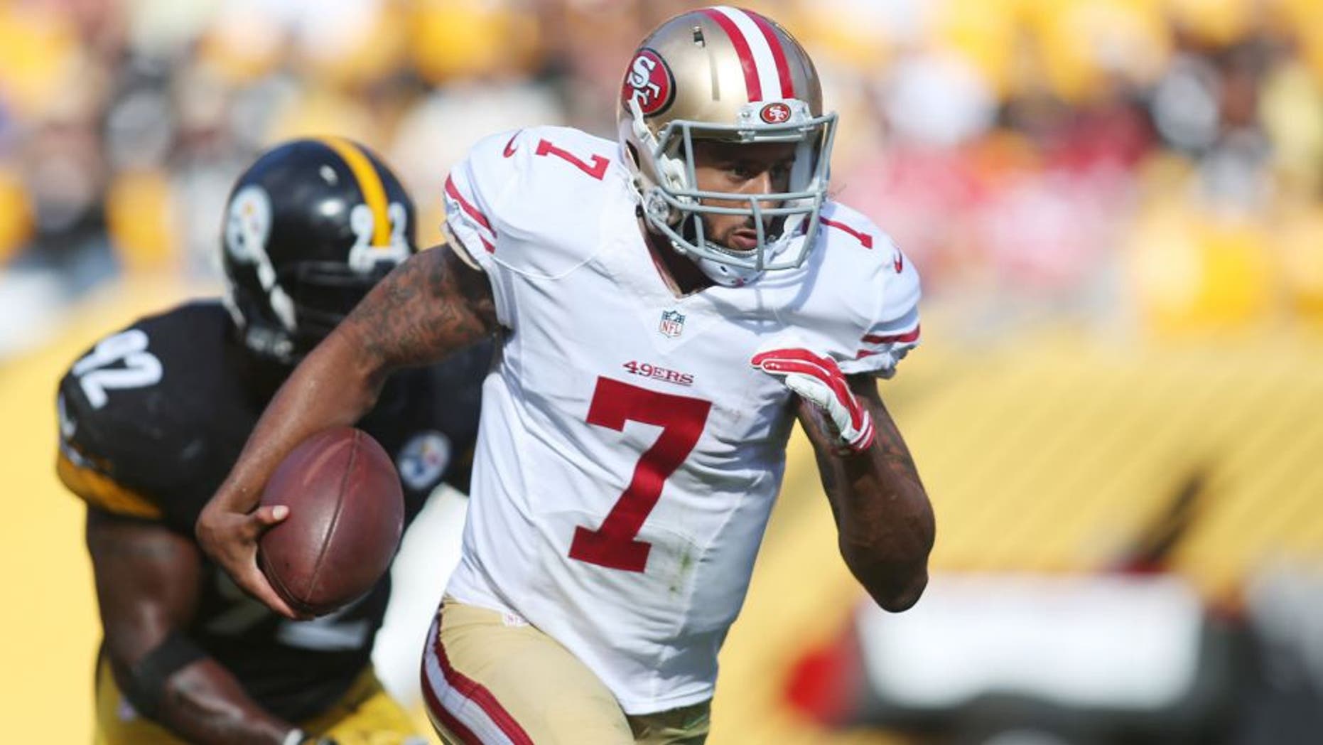 Sep 20, 2015; Pittsburgh, PA, USA; San Francisco 49ers quarterback Colin Kaepernick (7) scrambles with the ball as Pittsburgh Steelers outside linebacker James Harrison (92) chases during the fourth quarter at Heinz Field. The Steelers won 43-18. Mandatory Credit: Charles LeClaire-USA TODAY Sports