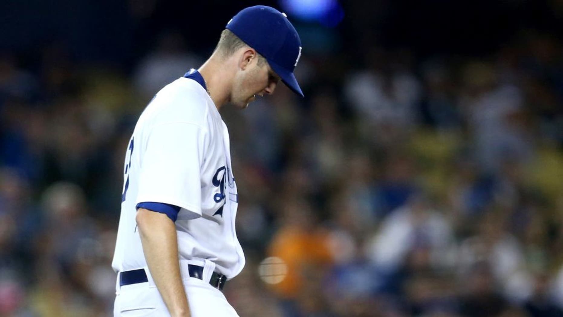 LOS ANGELES, CA - SEPTEMBER 22: Pitcher Alex Wood #57 of the Los Angeles Dodgers reacts after giving up a solo home run in the seventh inning to A.J. Pollock of the Arizona Diamondbacks at Dodger Stadium on September 22, 2015 in Los Angeles, California. (Photo by Stephen Dunn/Getty Images)