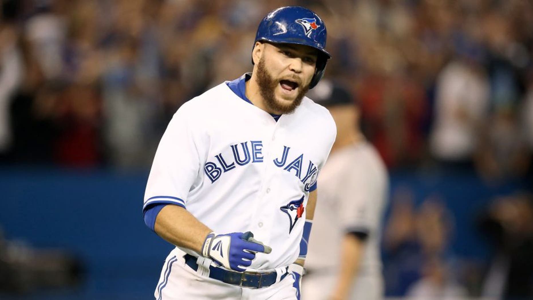 TORONTO, CANADA - SEPTEMBER 23: Russell Martin #55 of the Toronto Blue Jays reacts as he hits a three-run home run in the seventh inning during MLB game action against the New York Yankees on September 23, 2015 at Rogers Centre in Toronto, Ontario, Canada. (Photo by Tom Szczerbowski/Getty Images)