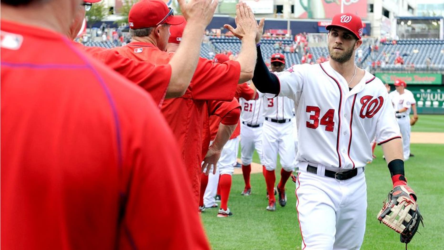 WASHINGTON, DC - SEPTEMBER 20: Bryce Harper #34 of the Washington Nationals celebrates with teammates after a 13-3 victory against the Miami Marlins at Nationals Park on September 20, 2015 in Washington, DC. (Photo by Greg Fiume/Getty Images)