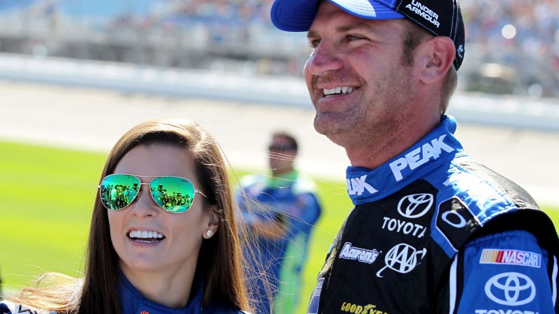 JOLIET, IL - SEPTEMBER 20: Danica Patrick, driver of the #10 Aspen Dental Chevrolet, and Clint Bowyer, driver of the #15 PEAK Antifreeze & Coolant Toyota, talk on the grid prior to the NASCAR Sprint Cup Series myAFibRisk.com 400 at Chicagoland Speedway on September 20, 2015 in Joliet, Illinois. (Photo by Kena Krutsinger/Getty Images)