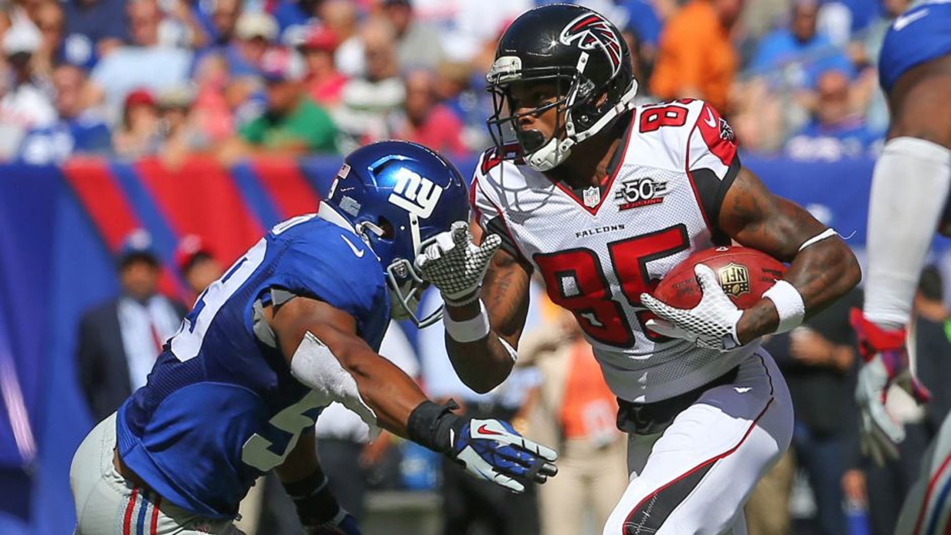 Sep 20, 2015; East Rutherford, NJ, USA; Atlanta Falcons wide receiver Leonard Hankerson (85) runs with the ball while New York Giants linebacker Devon Kennard (59) looks to make a tackle during the first half at MetLife Stadium. Mandatory Credit: Ed Mulholland-USA TODAY Sports