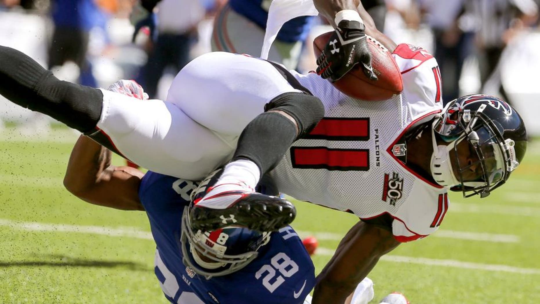 Sep 20, 2015; East Rutherford, NJ, USA; (11) is tackled by New York Giants cornerback Jayron Hosley (28) during the first half at MetLife Stadium. Mandatory Credit: Ed Mulholland-USA TODAY Sports