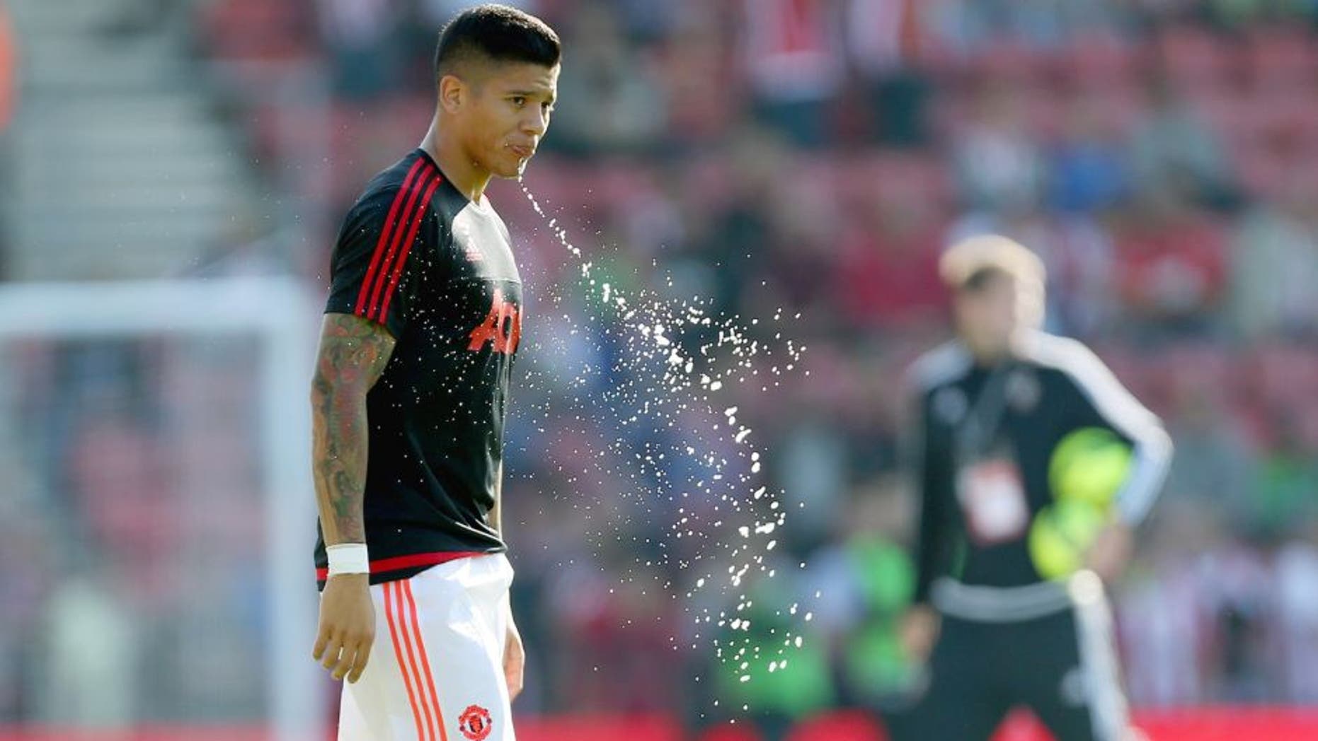 SOUTHAMPTON, ENGLAND - SEPTEMBER 20: Marcos Rojo of Manchester United spits out some water before the Barclays Premier League match at St Mary's stadium between Southampton and Manchester United on September 20, 2015 in Southampton, United Kingdom. (Photo by Catherine Ivill - AMA/Getty Images)