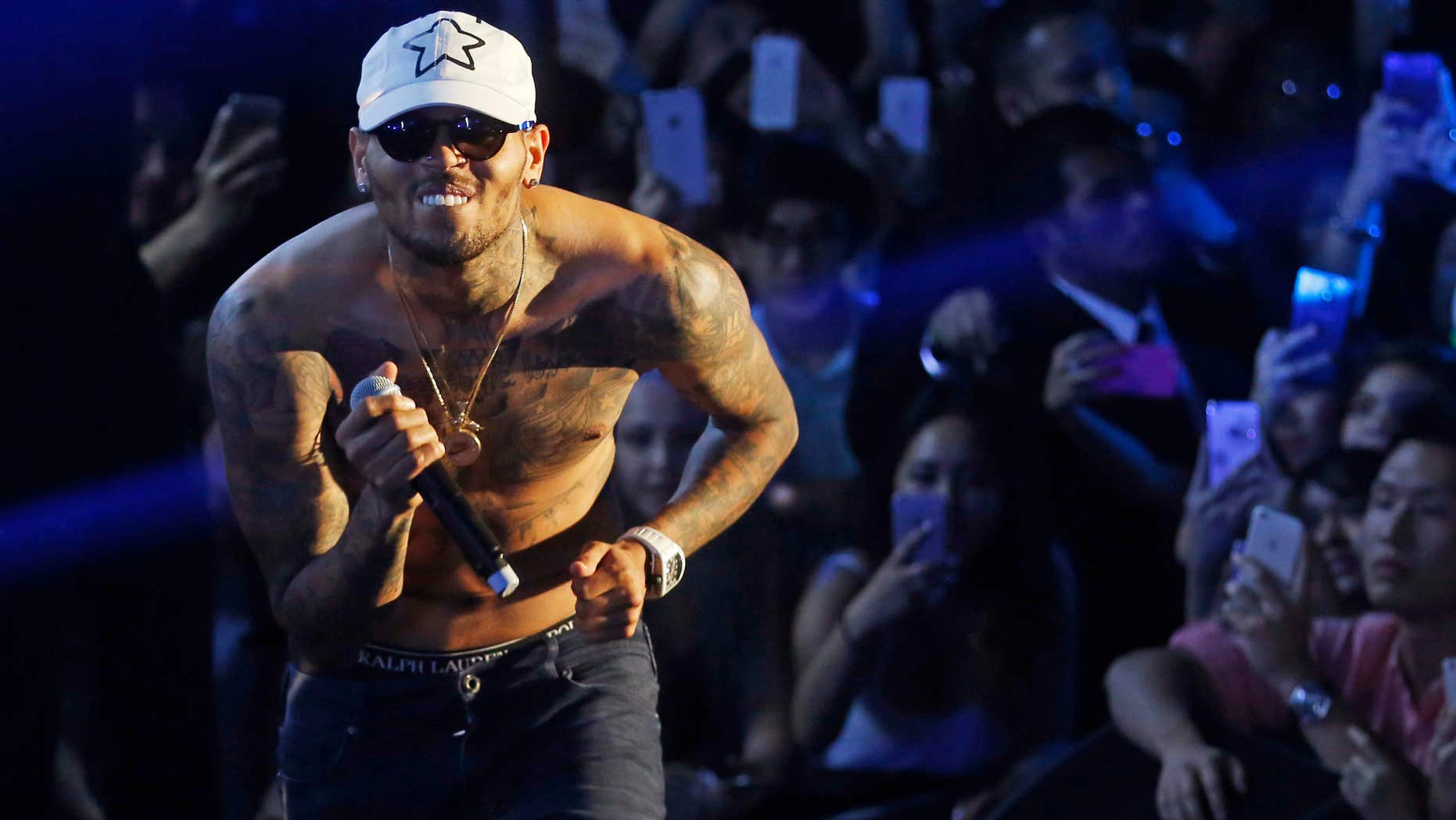 FILE - In this July 25, 2015 file photo, Grammy award-winning singer Chris Brown performs at a club in Macau.