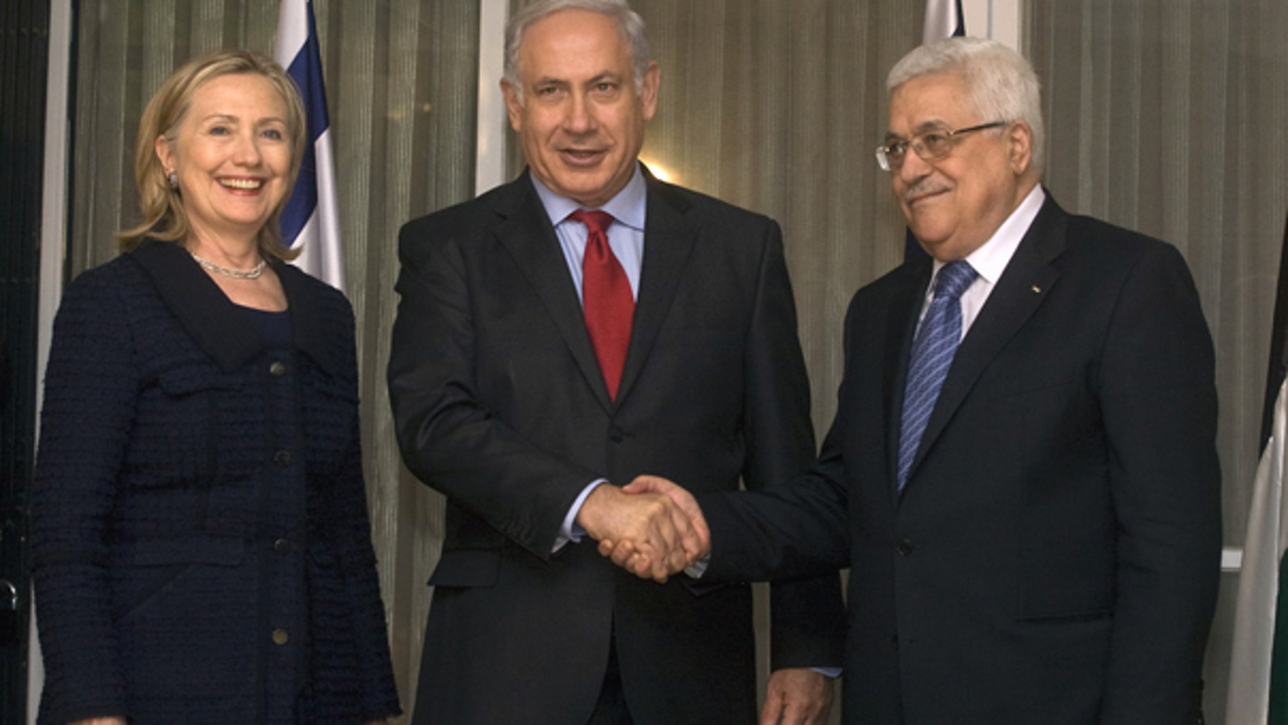 Sept. 15: Israeli Prime Minister Benjamin Netanyahu, center, shakes hands with Palestinian President Mahmoud Abbas, right, as Secretary of State Hillary Rodham Clinton smiles during a meeting at the Prime Ministers' residence in Jerusalem, Israel.