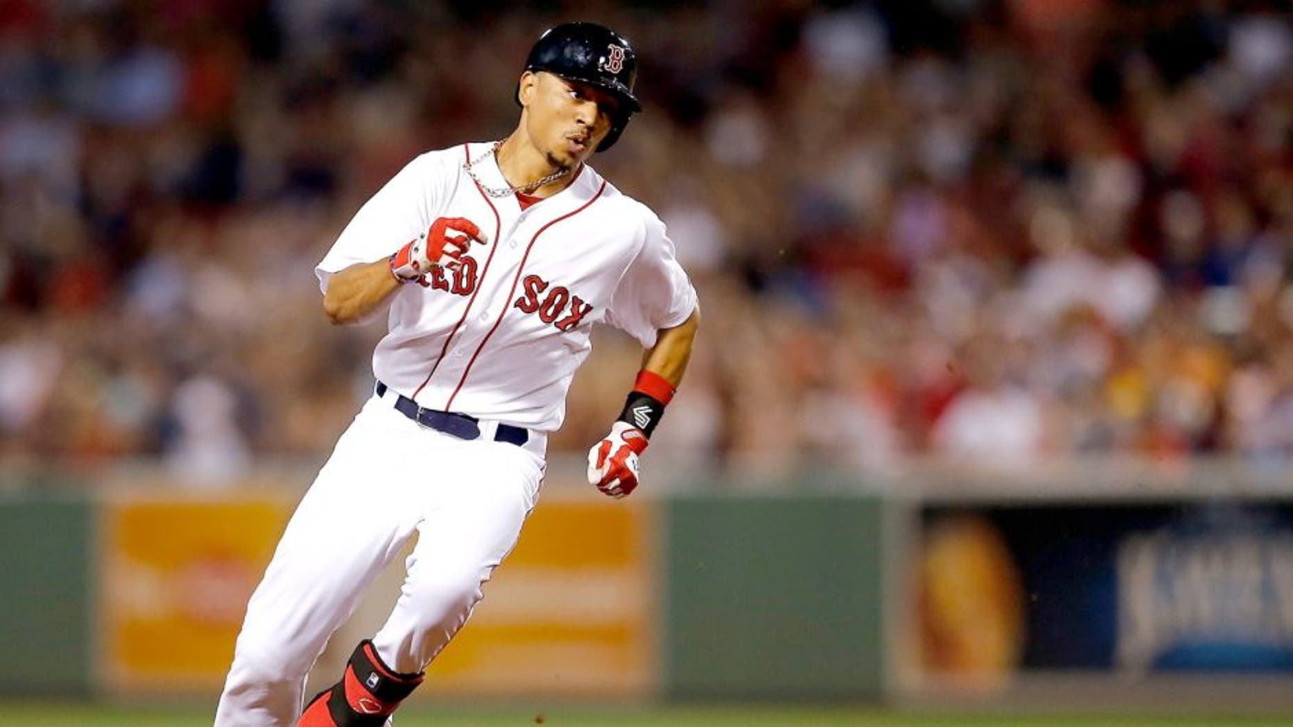 BOSTON, MA - SEPTEMBER 6: Mookie Betts #50 of the Boston Red Sox runs out a triple against the Toronto Blue Jays in the second inning at Fenway Park on September 6, 2014 in Boston, Massachusetts. (Photo by Jim Rogash/Getty Images)