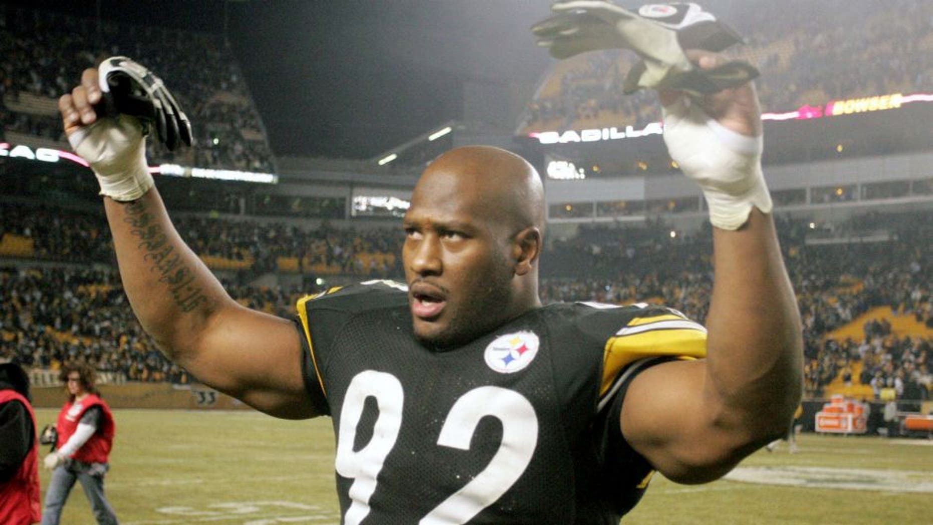 January 15, 2011; Pittsburgh, PA, USA: Pittsburgh Steelers linebacker James Harrison (92) raises his arms in celebration after defeating the Baltimore Ravens in the 2011 AFC divisional playoff game at Heinz Field. The Steelers won 31-24. Mandatory Credit: Charles LeClaire-USPRESSWIRE