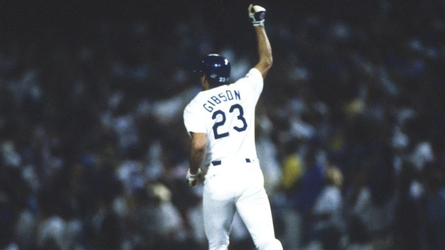 LOS ANGELES, CA - OCTOBER 15: Los Angeles Dodgers' Kirk Gibson #23 gestures to the crowd after hitting a home run during the World Series against the Oakland Athletics at Dodger Stadium on October 15, 1988 in Los Angeles, California. The Dodgers defeated the Athletics 5-4 in game 1 of the series. (Photo by Focus on Sport/Getty Images) *** Local Caption *** Kirk Gibson
