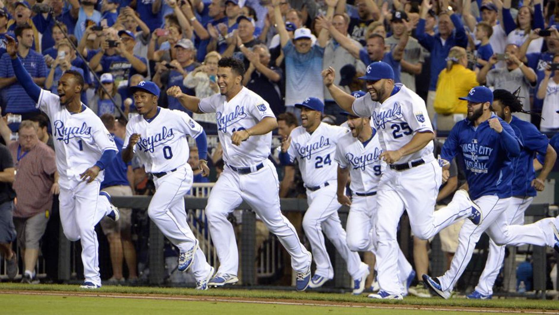 Sep 24, 2015; Kansas City, MO, USA; Kansas City Royals players celebrate after the game against the Seattle Mariners at Kauffman Stadium. Kansas City won the game 10-4 and won the American League central division. Mandatory Credit: John Rieger-USA TODAY Sports