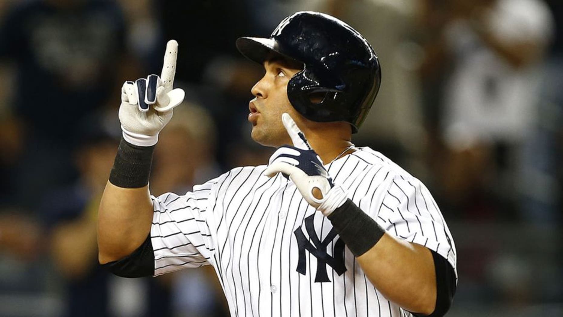 NEW YORK, NY - SEPTEMBER 24: Carlos Beltran #36 of the New York Yankees gestures after hitting a three-run home run against the Chicago White Sox during the third inning of a MLB baseball game at Yankee Stadium on September 24, 2015 in the Bronx borough of New York City. The Yankees defeated the White Sox 3-2. (Photo by Rich Schultz/Getty Images)