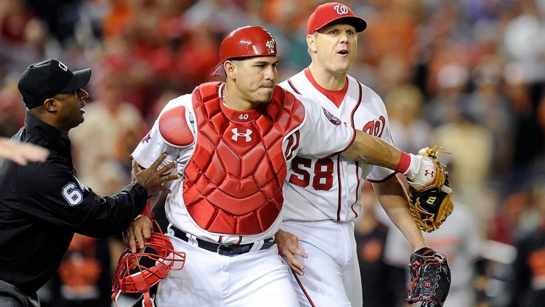WASHINGTON, DC - SEPTEMBER 23: Jonathan Papelbon #58 of the Washington Nationals is restrained by Wilson Ramos #40 after being thrown out of the game in the ninth inning against the Baltimore Orioles at Nationals Park on September 23, 2015 in Washington, DC. (Photo by Greg Fiume/Getty Images)